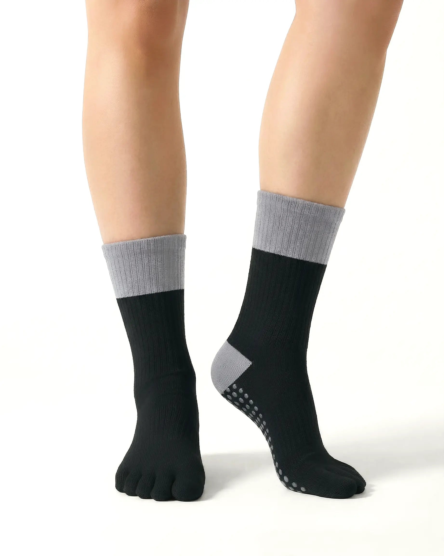black | 04 | Black color block five-toe grip socks front standing view showing five-toe silhouette, contrast toe and heel panels, and studio-ready grip styling