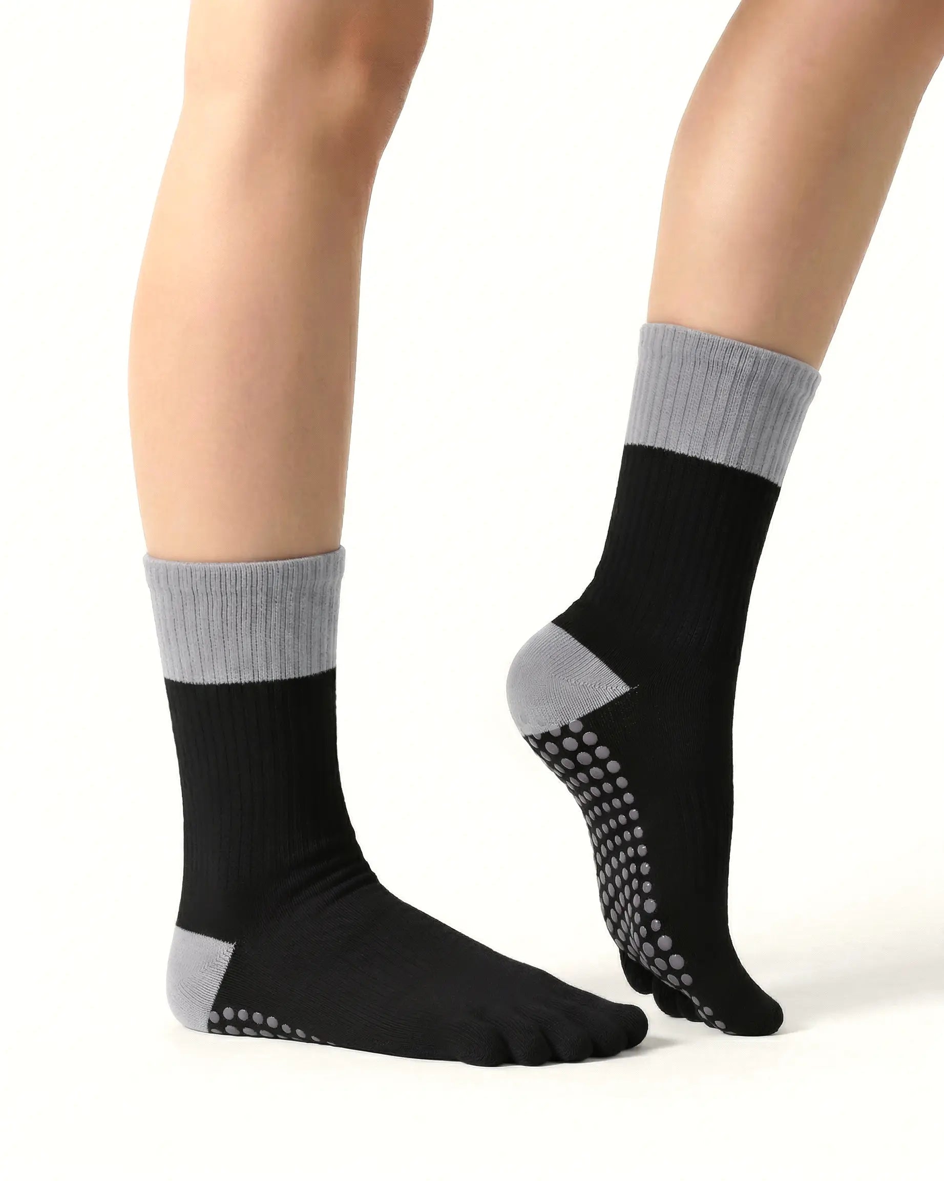 black | 03 | Black color block five-toe grip socks side close-up view showing contrast cuff, ribbed body, and structured knit detail
