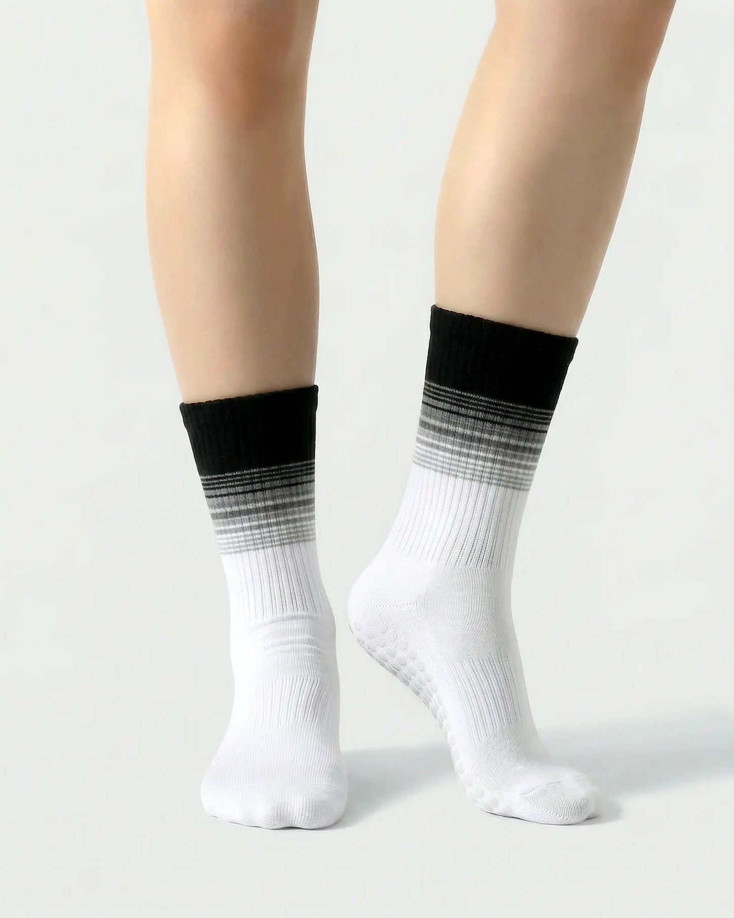 black-white | 04 | Crew grip socks front standing view showing black-white gradient stripe detail, crew length fit, and non-slip sole support
