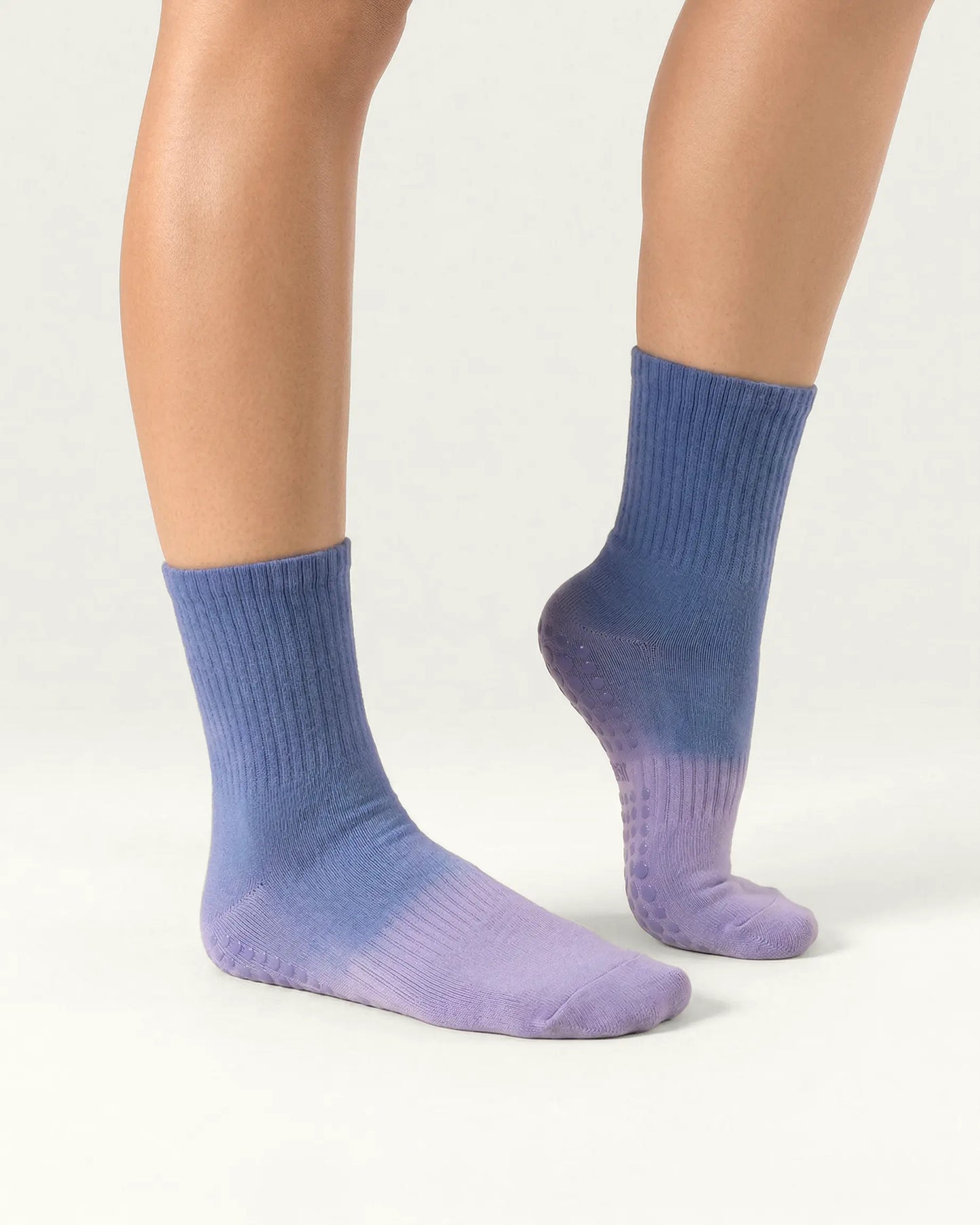 blue-purple | 03 | Blue purple gradient mid-crew grip socks side standing view showing ribbed structure, soft ombré transition, and grip sole coverage