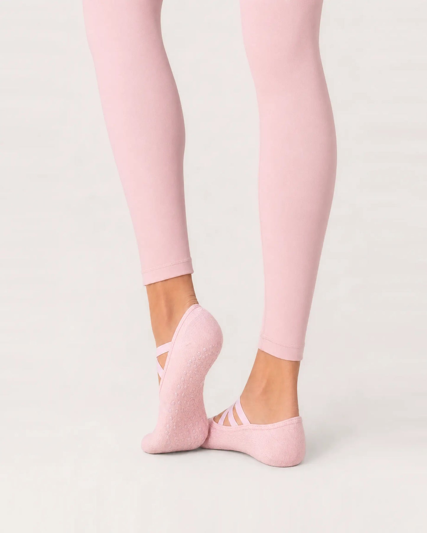 blush-pink | 04 | Blush pink Color-Pop Low-Cut Grip Socks rear angled sole view showing the full-sole grip pattern, covered heel, and low-cut construction