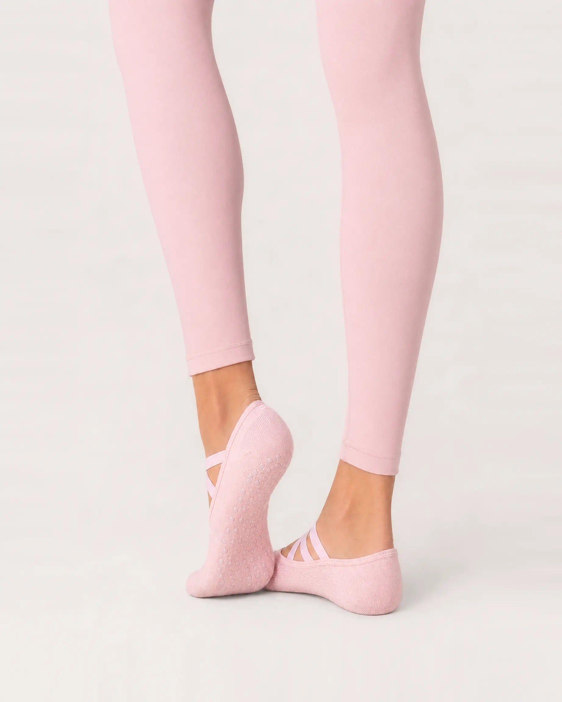 blush-pink | 04 | Blush pink Color-Pop Low-Cut Grip Socks rear angled sole view showing the full-sole grip pattern, covered heel, and low-cut construction