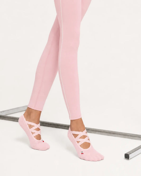 blush-pink | 02 | Blush pink Color-Pop Low-Cut Grip Socks side angled standing view showing the lightweight low-cut silhouette, crisscross straps, and covered heel