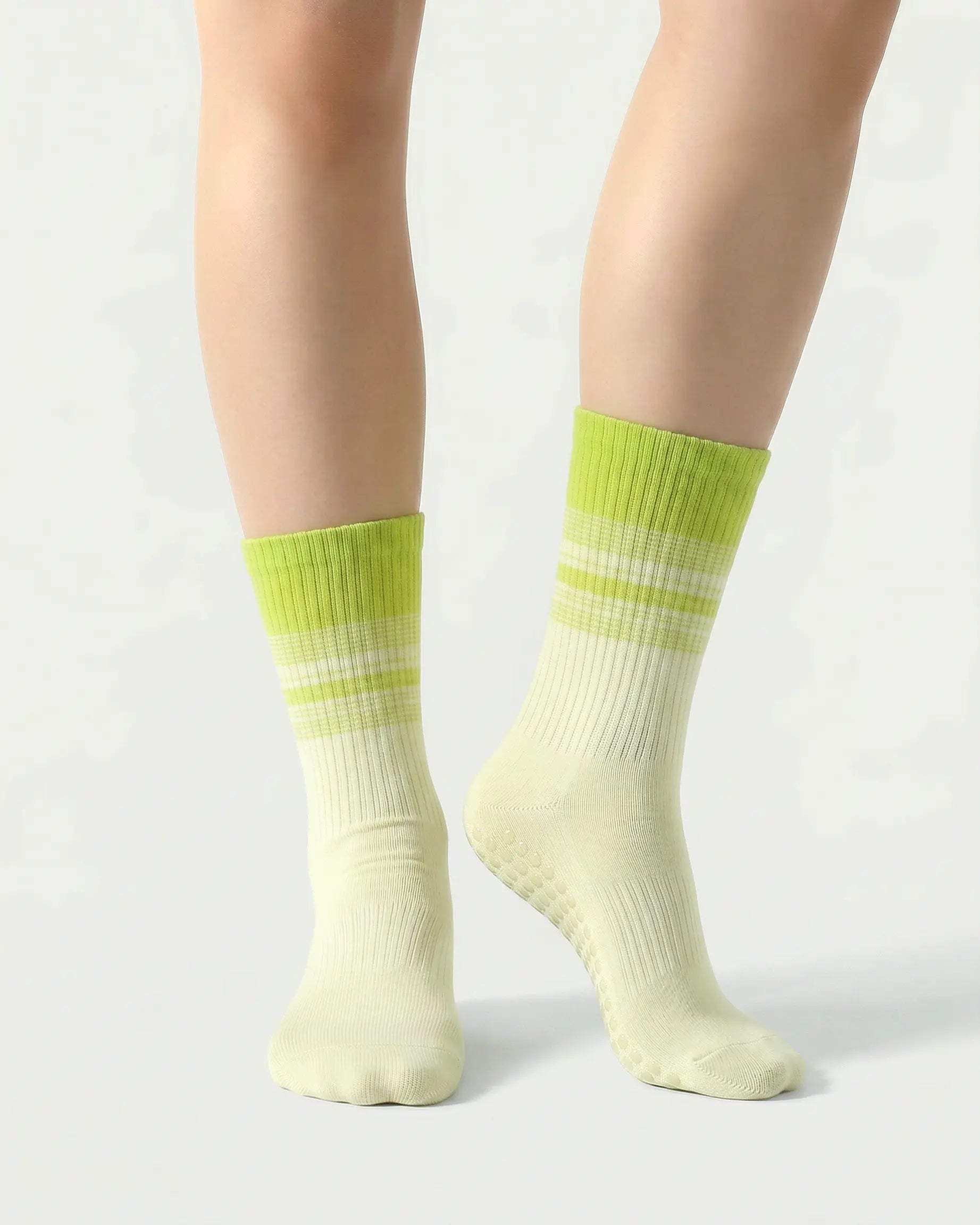 green | 04 | Crew grip socks front standing view showing green  gradient stripe detail, crew length fit, and non-slip sole support