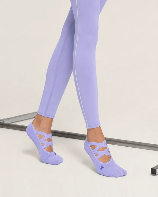 lavender | 02 | Lavender Color-Pop Low-Cut Grip Socks side angled standing view showing the lightweight low-cut silhouette, crisscross straps, and covered heel
