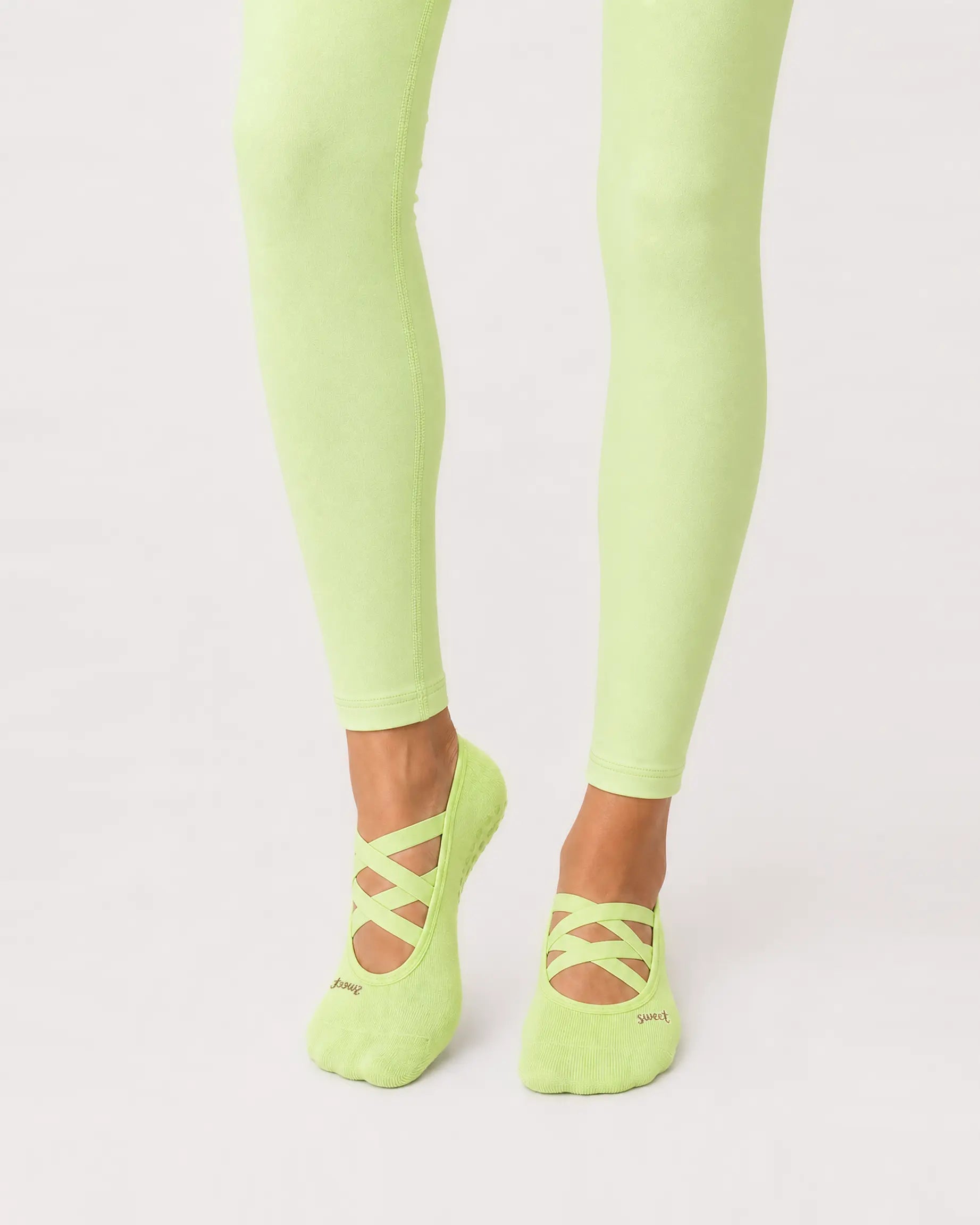 lime | 01 | Lime Color-Pop Low-Cut Grip Socks front angled standing view showing the open-instep crisscross straps, low-cut fit, and mini embroidery detail