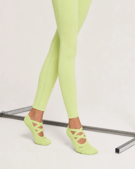 lime | 02 | Lime Color-Pop Low-Cut Grip Socks side angled standing view showing the lightweight low-cut silhouette, crisscross straps, and covered heel