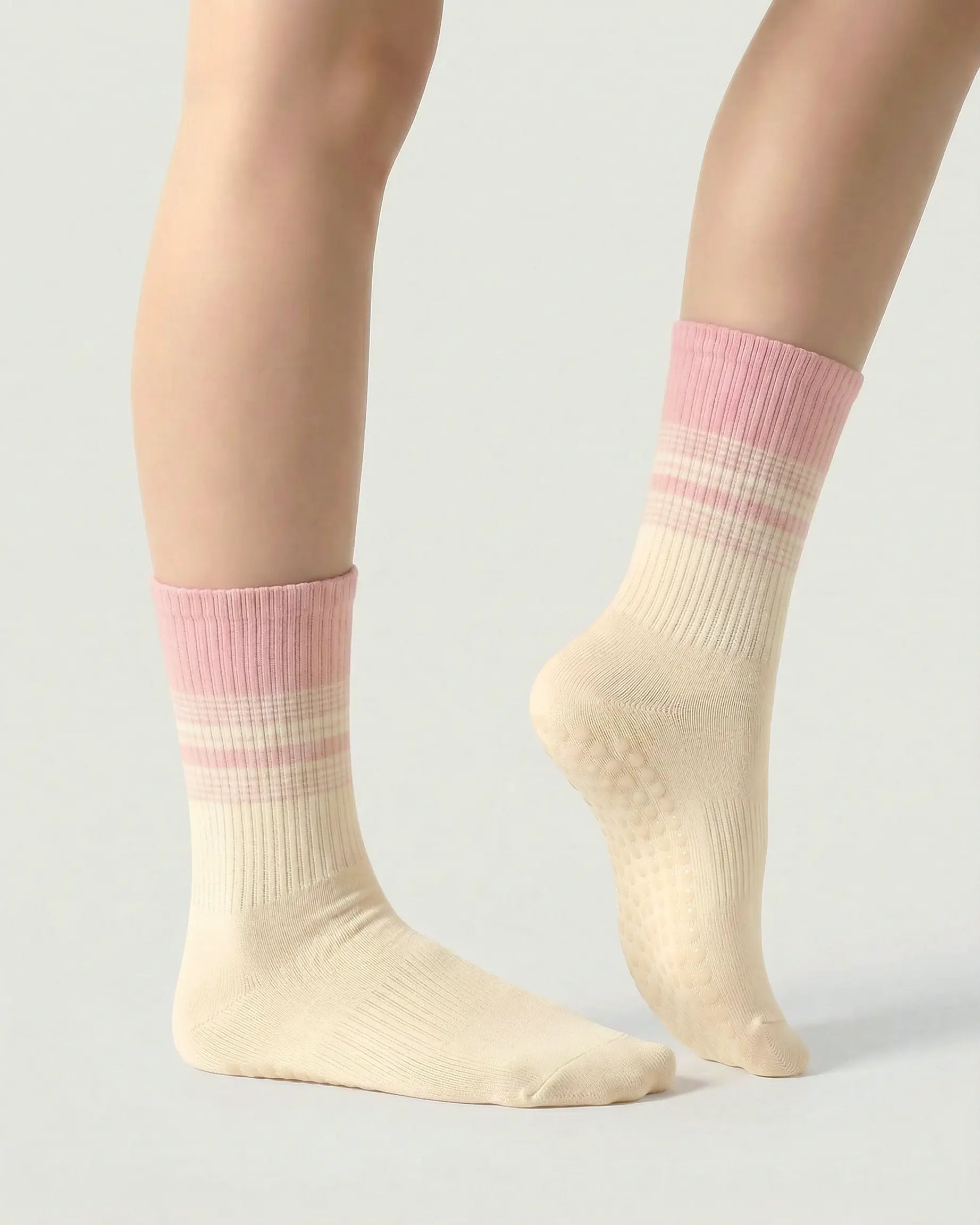 pink-apricot | 03 | Crew grip socks side standing view showing soft pink and apricot contrast stripes, cream base, and refined studio silhouette