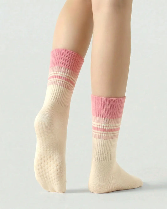 pink-apricot | 02 | Crew grip socks tiptoe standing view showing pink-apricot gradient striping, ribbed structure, and full sole grip coverage