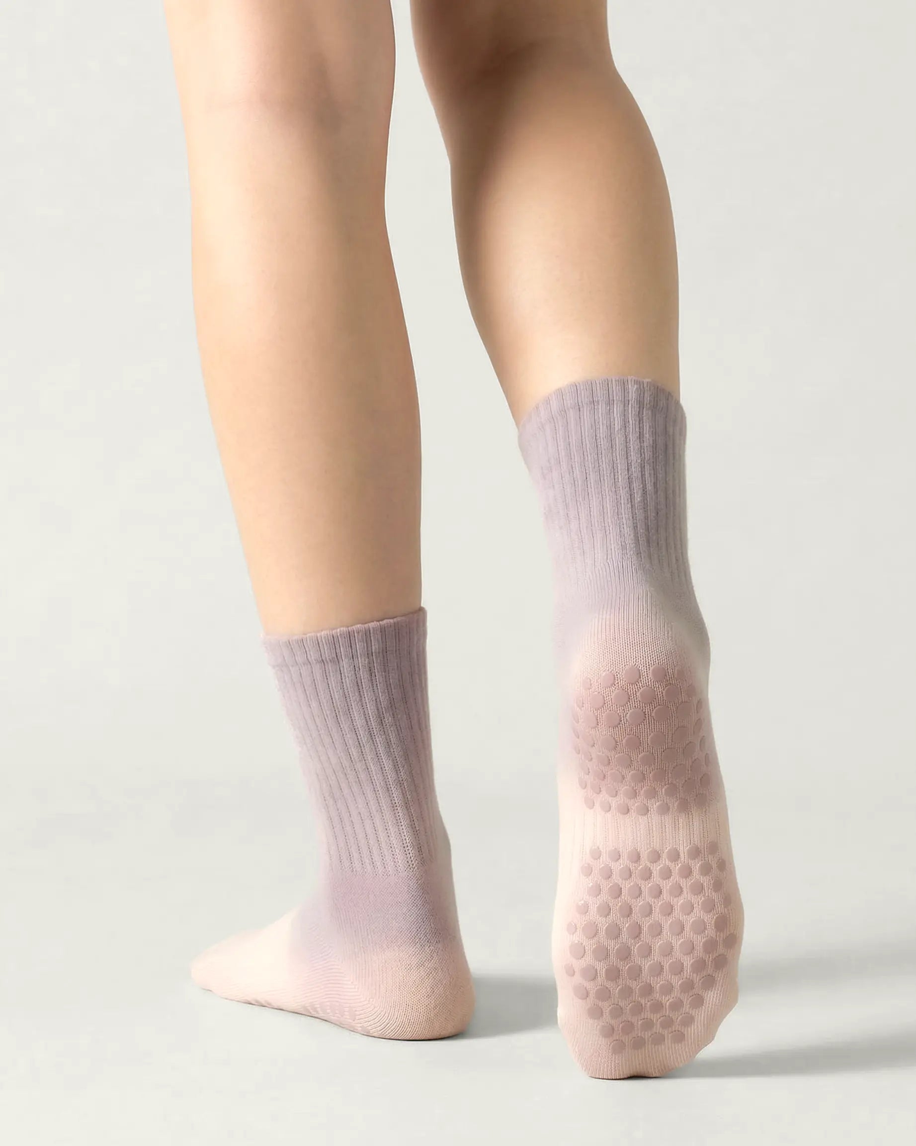 pink-grey | 02 | Pink grey gradient mid-crew grip socks back standing view showing heel-to-cuff gradient fade, ribbed structure, and full sole grip coverage