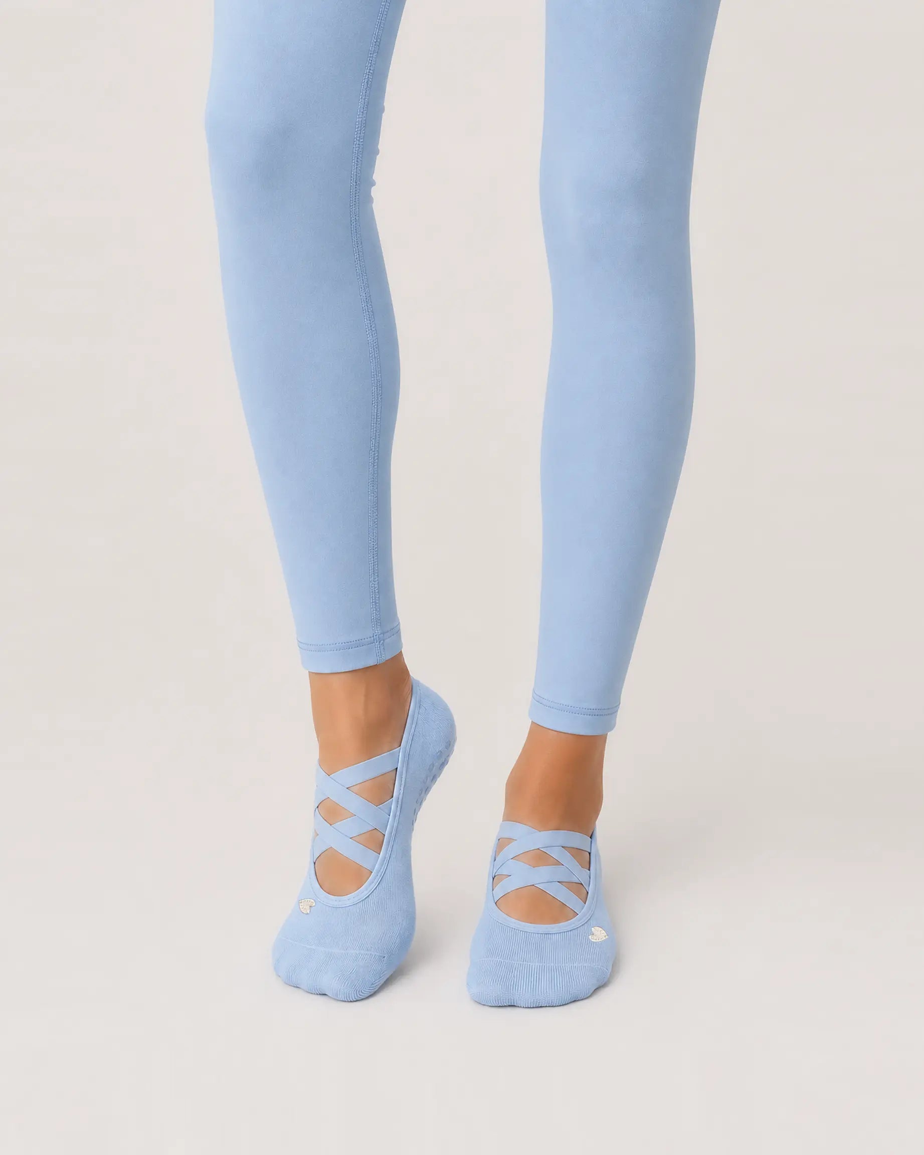 sky-blue | 01 | Sky blue Color-Pop Low-Cut Grip Socks front angled standing view showing the open-instep crisscross straps, low-cut fit, and mini embroidery detail