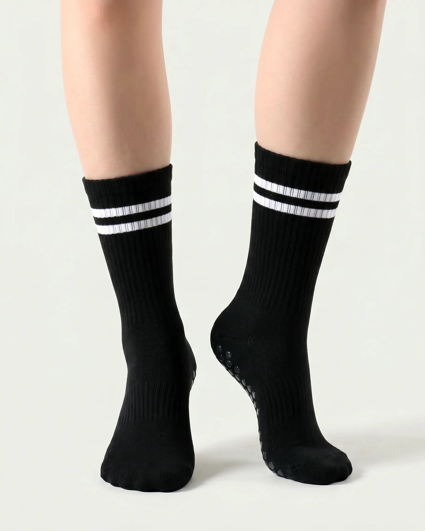 black | 04 | Black double-stripe crew grip socks front angled view showing ribbed texture, stripe detail, and crew height