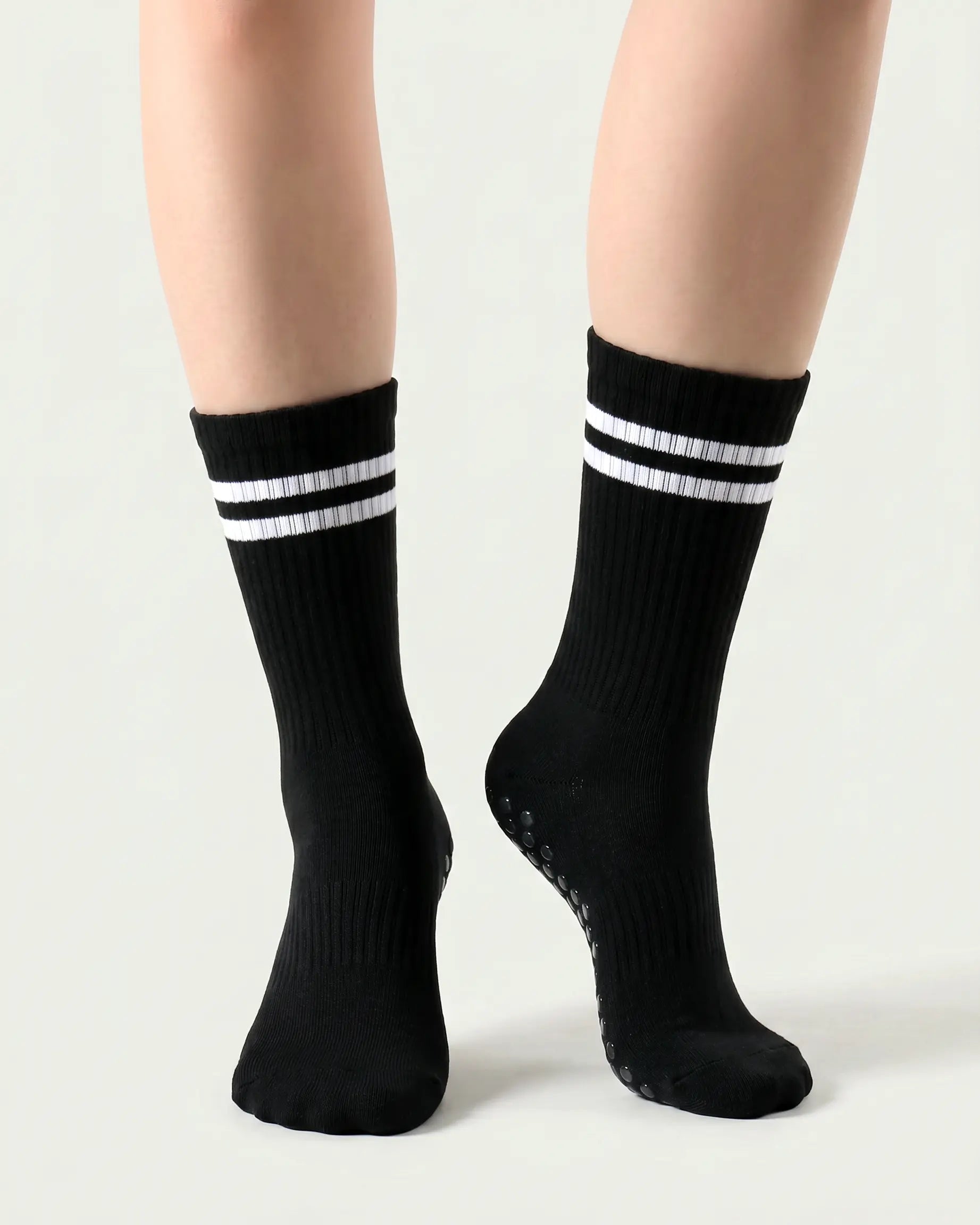 black | 04 | Black double-stripe crew grip socks front angled view showing ribbed texture, stripe detail, and crew height