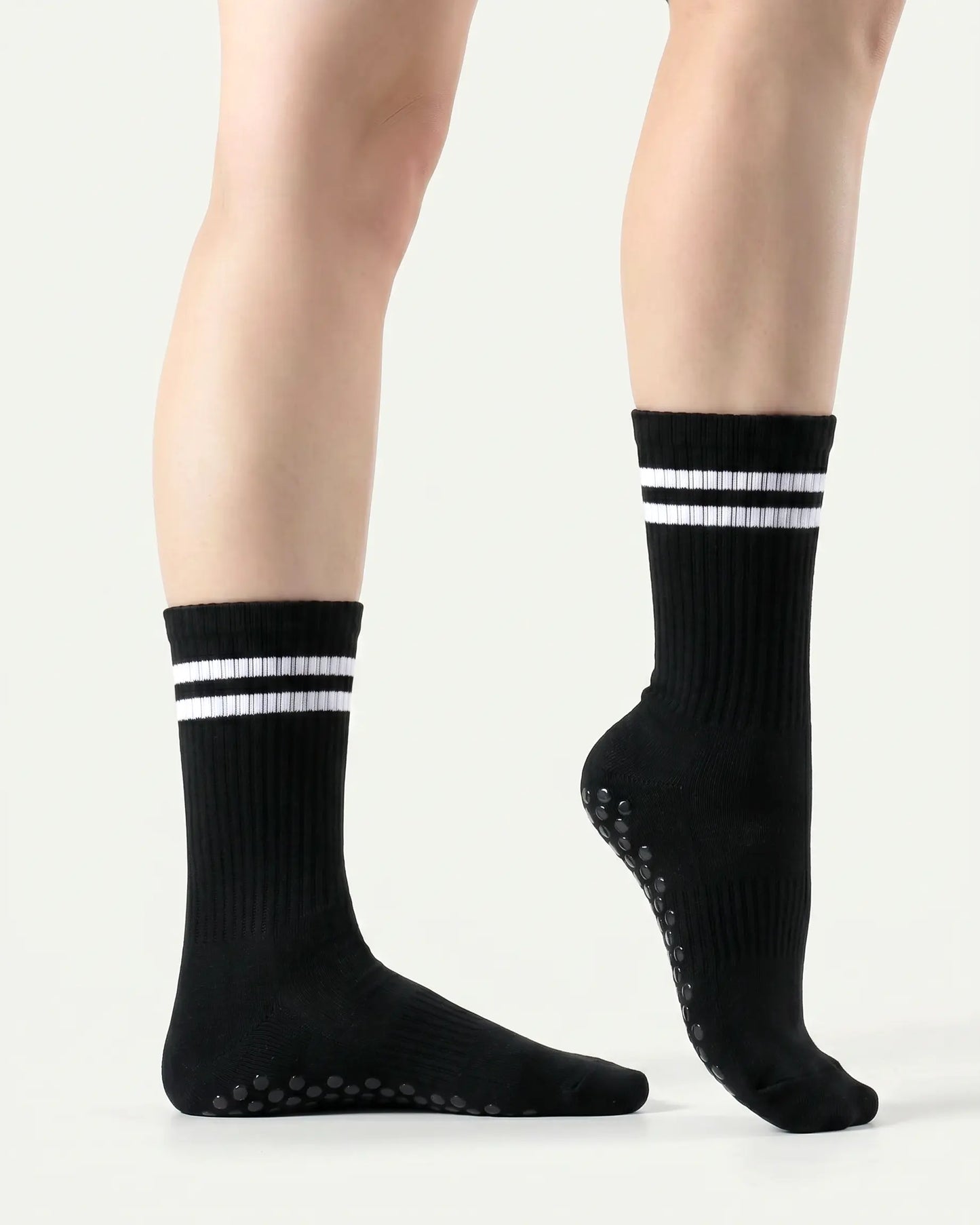 black | 03 | Black double-stripe crew grip socks side standing view showing clean silhouette, contrast stripe detail, and crew fit
