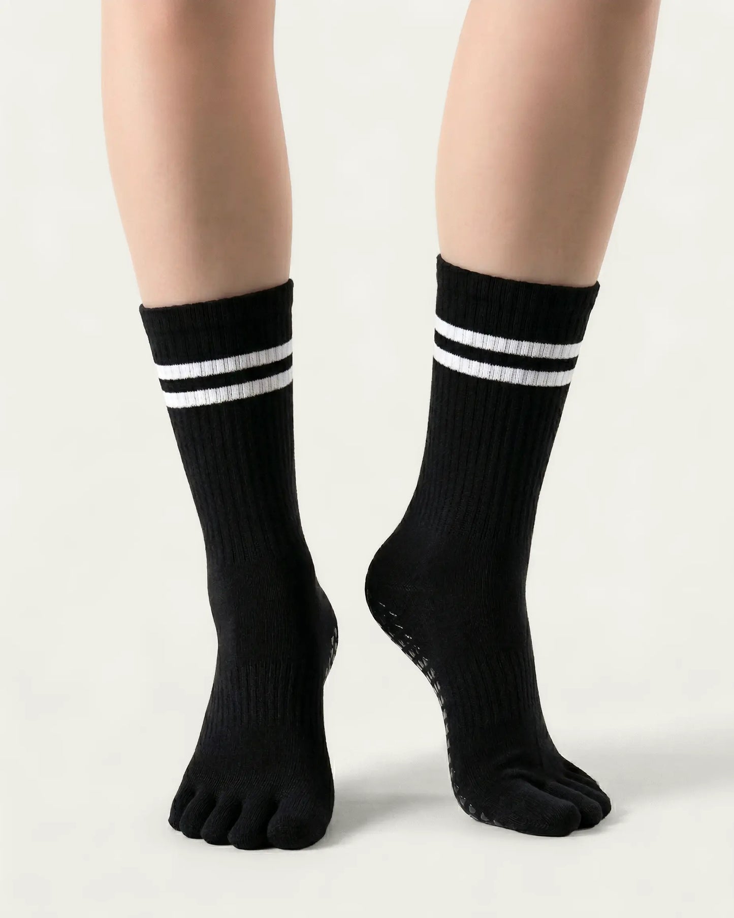 black | 04 | Black double-stripe five-toe grip socks front standing view showing stripe detail, toe separation, and overall fit
