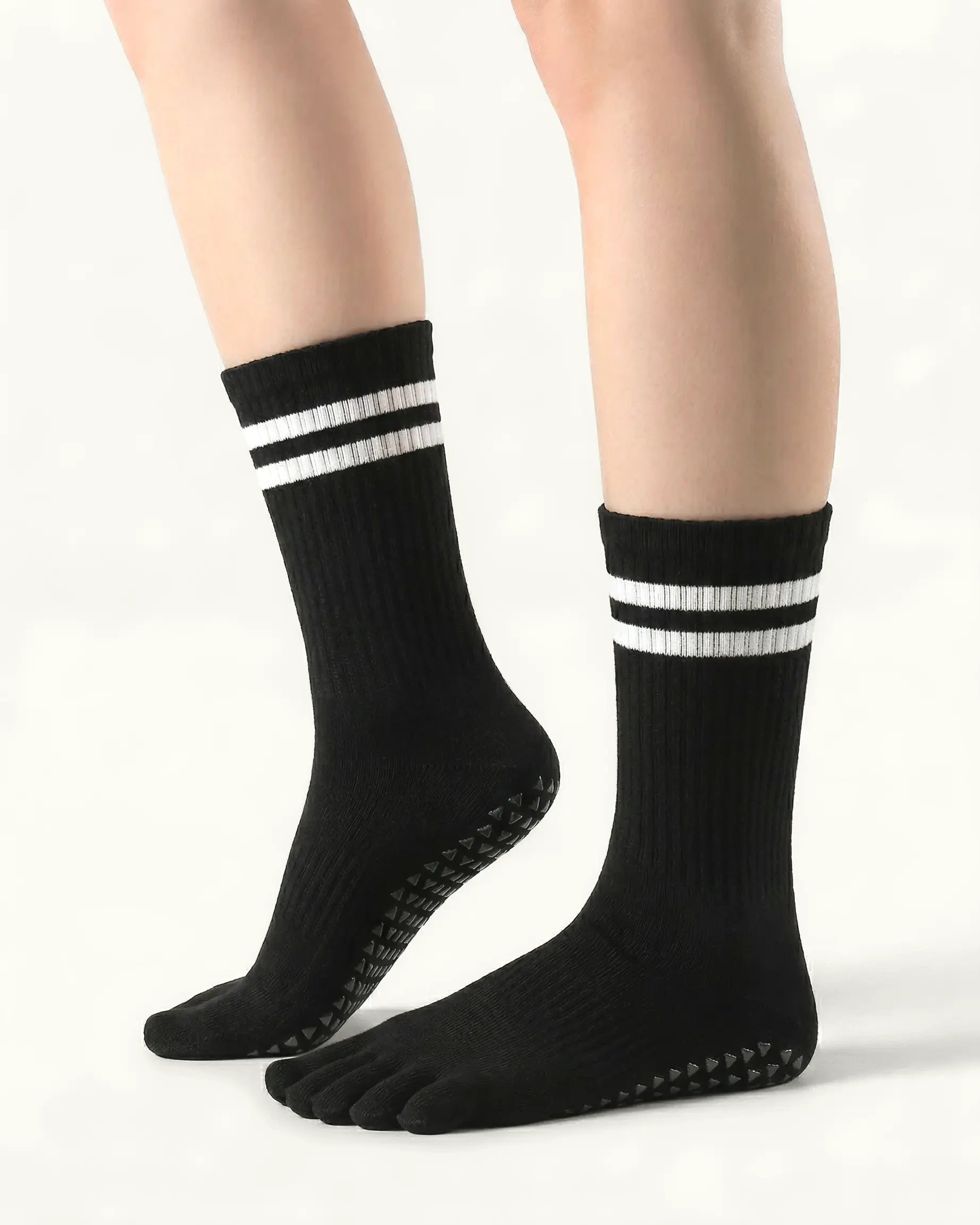 black| 01 | Black double-stripe five-toe grip socks side lift view showing ribbed texture, stripe detail, and toe separation