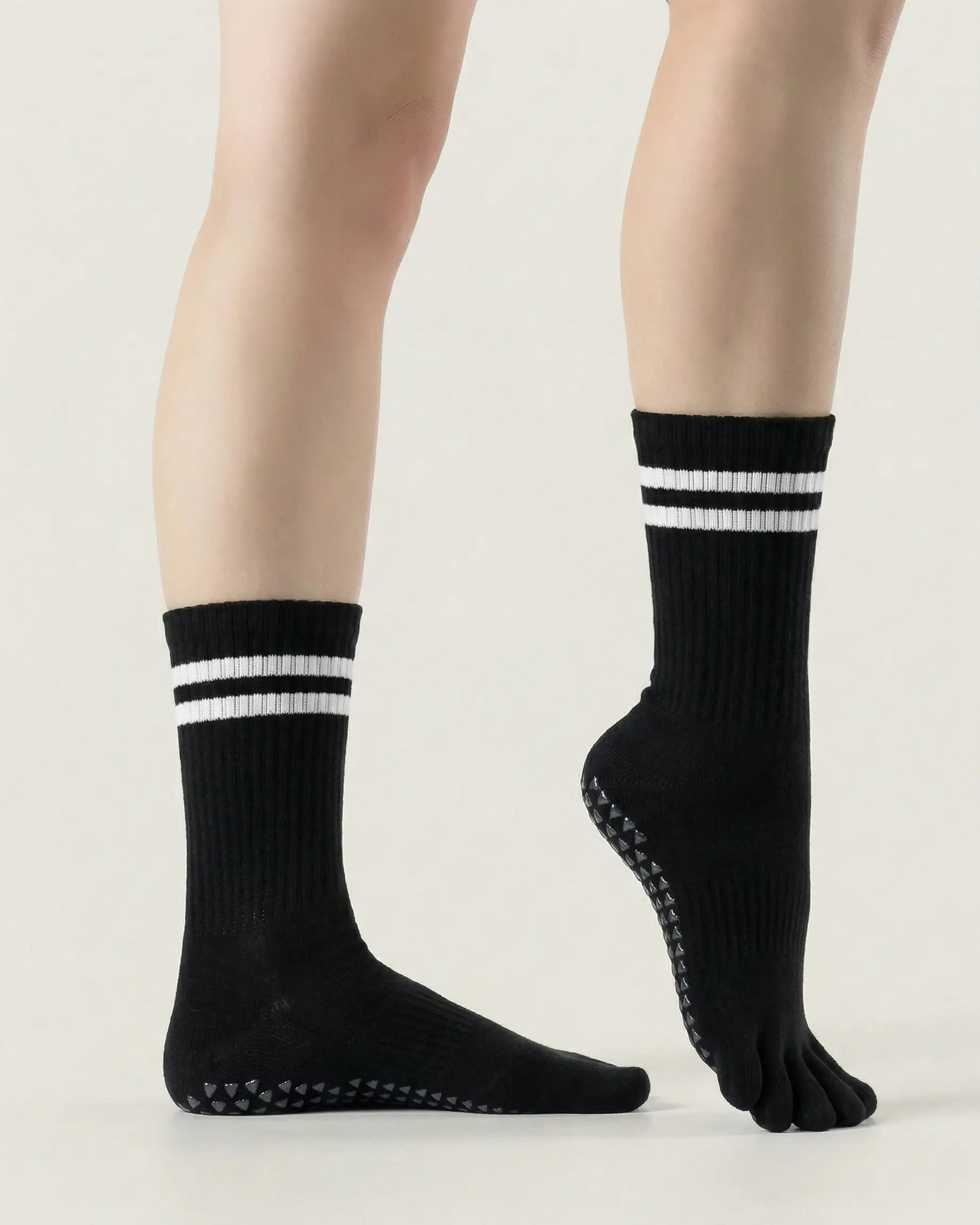 black | 03 | Black double-stripe five-toe grip socks side standing view showing ribbed texture, stripe detail, and five-toe silhouette