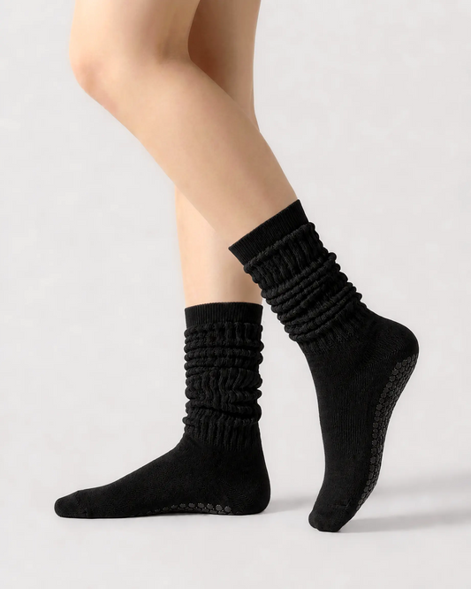 black | 01 | Black slouch grip socks side slouch standing view showing relaxed ribbed texture, crew length, and soft studio styling
