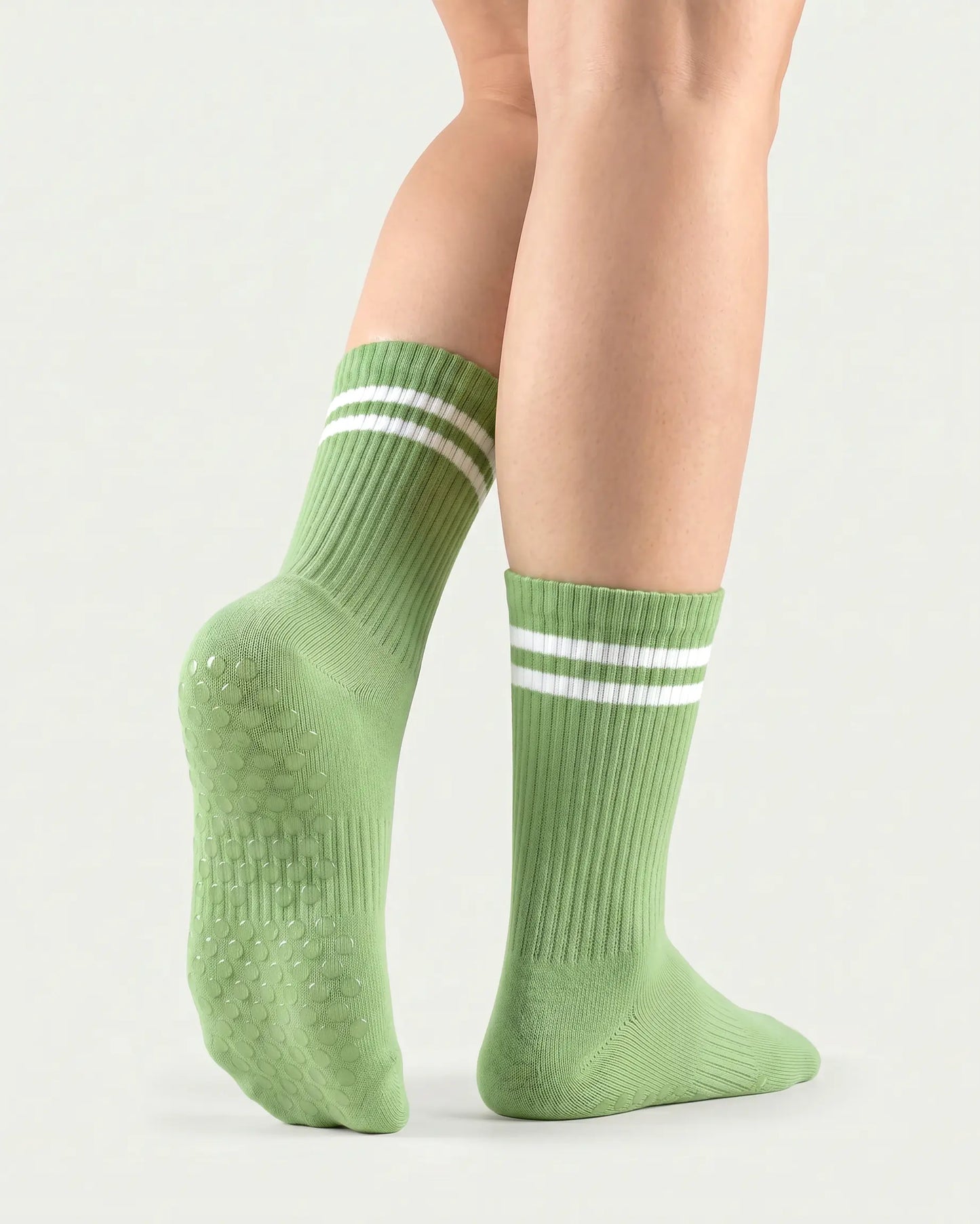 green | 02 | Green double-stripe crew grip socks back view showing sole grip pattern, ribbed knit texture, and stripe detail