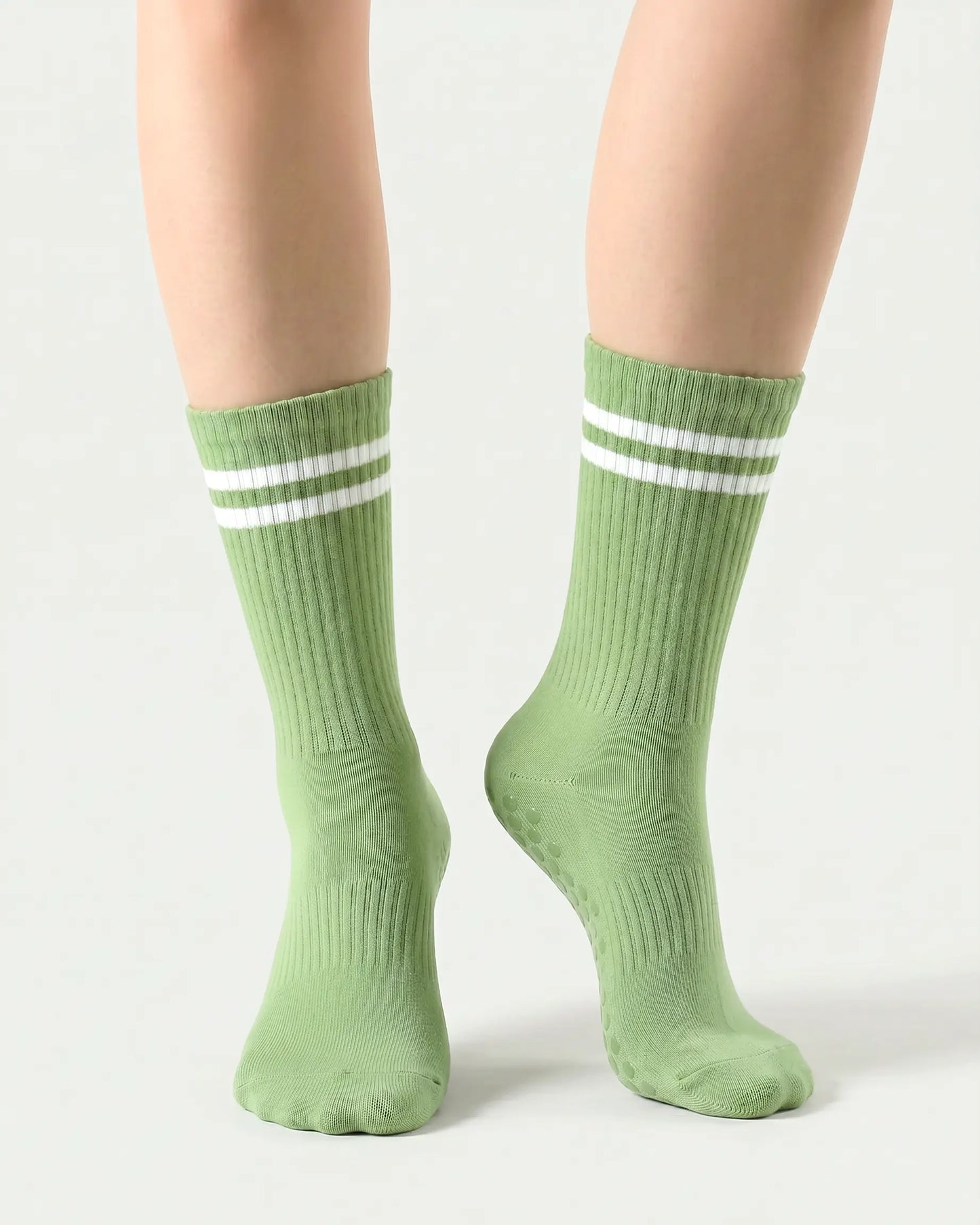 green | 04 | Green double-stripe crew grip socks front angled view showing ribbed texture, stripe detail, and crew height