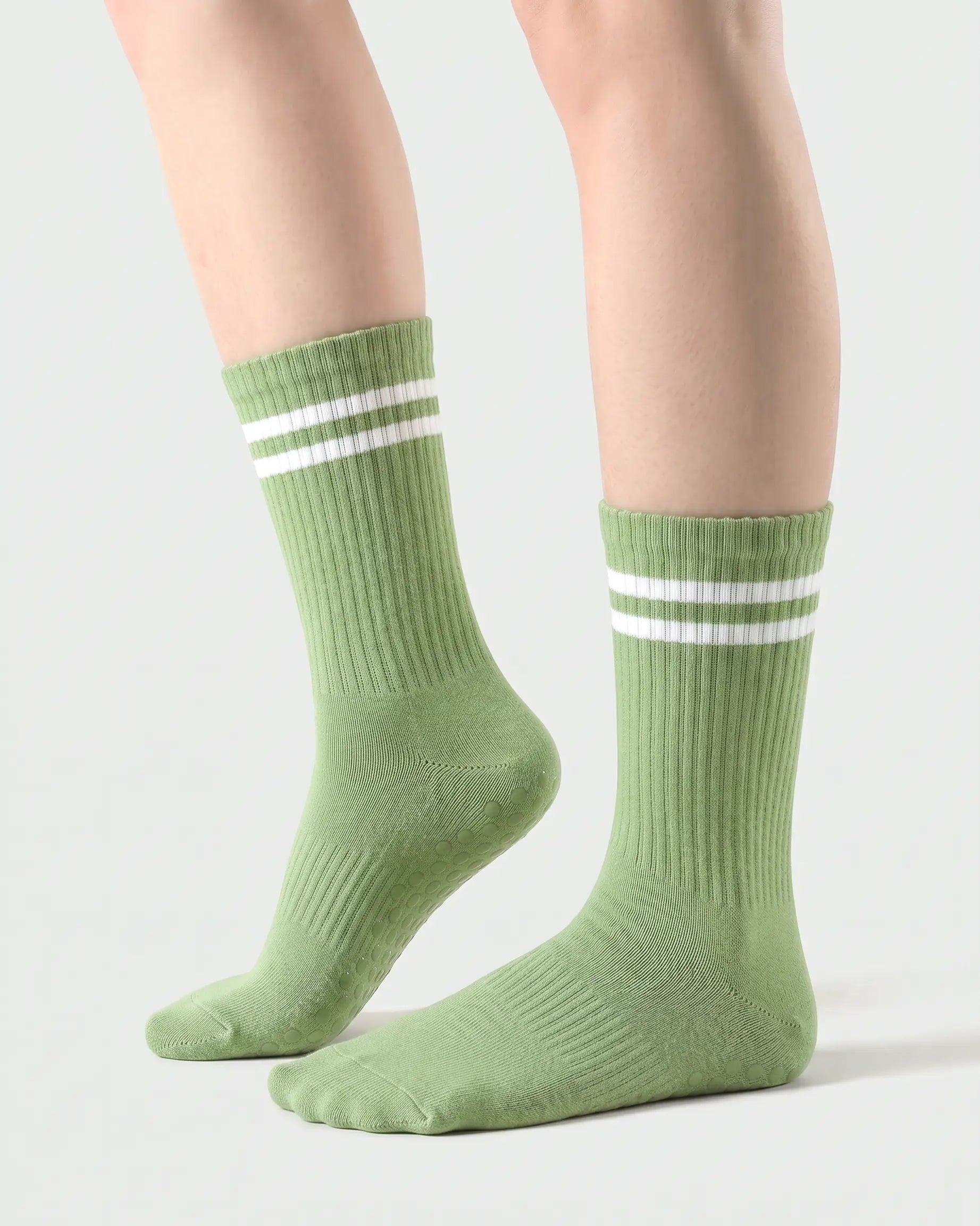 green | 01 | Green double-stripe crew grip socks side lift view showing ribbed texture, contrast stripe detail, and crew length