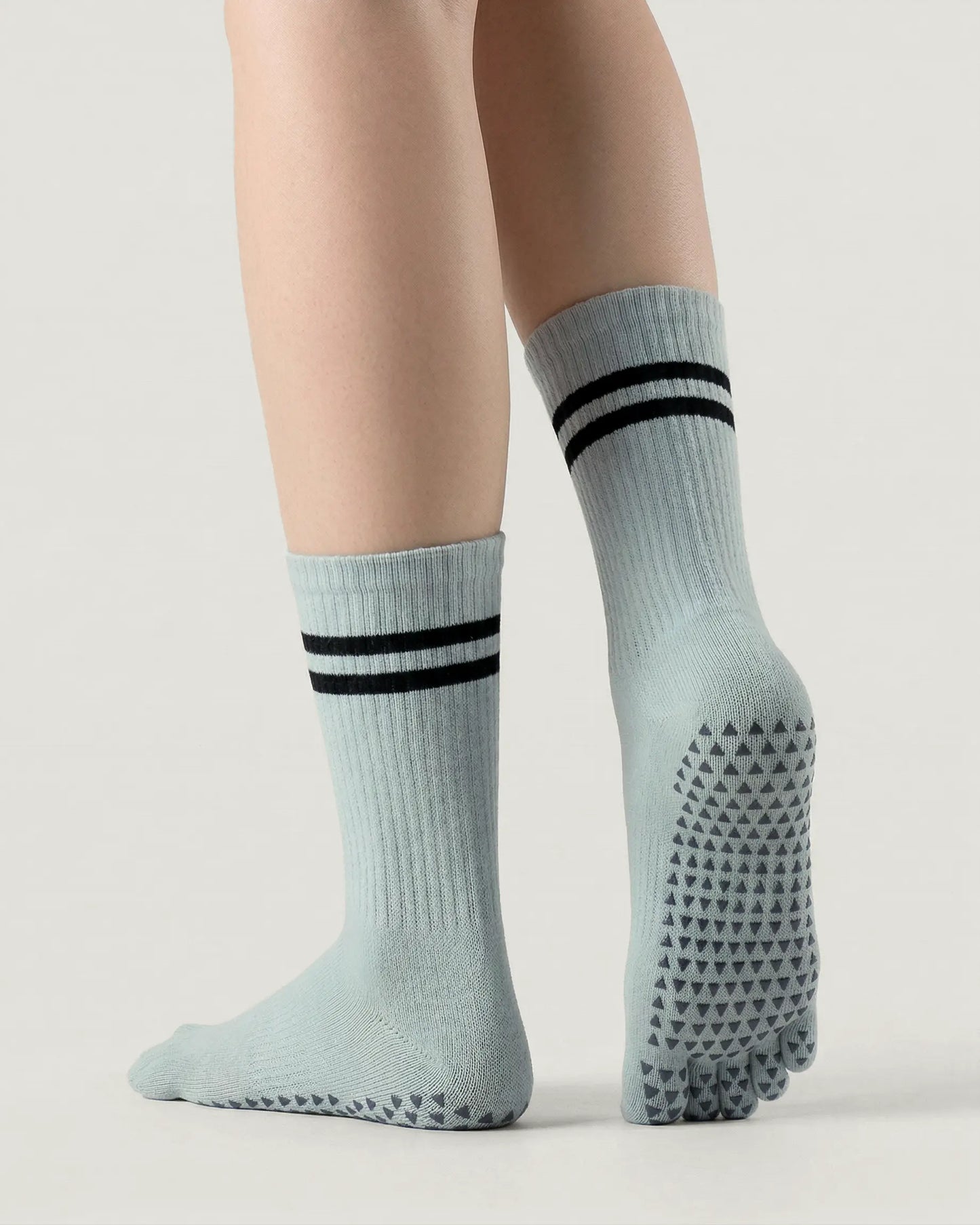 grey-green | 02 | Grey green double-stripe five-toe grip socks back view showing sole grip pattern, stripe detail, and ribbed knit texture