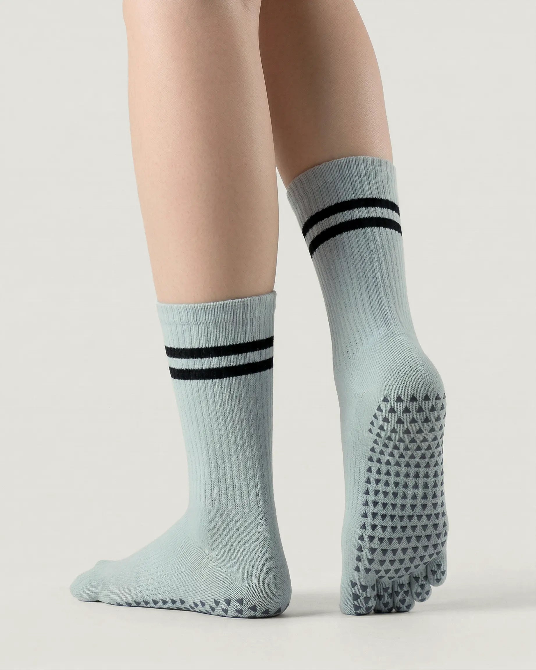 grey-green | 02 | Grey green double-stripe five-toe grip socks back view showing sole grip pattern, stripe detail, and ribbed knit texture