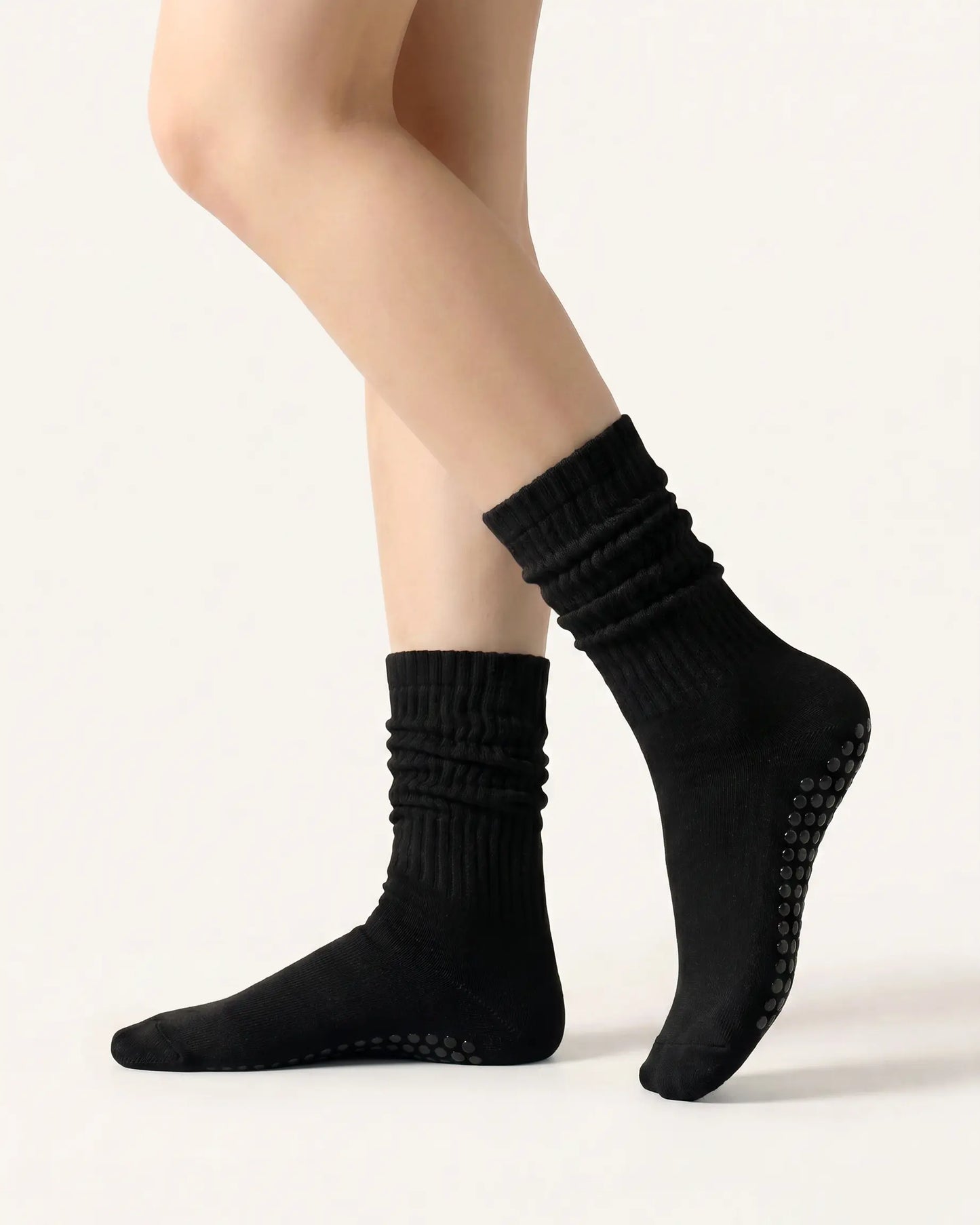 black | 01 | Black slouch grip socks side slouch standing view showing relaxed ribbed texture, crew length, and soft studio styling