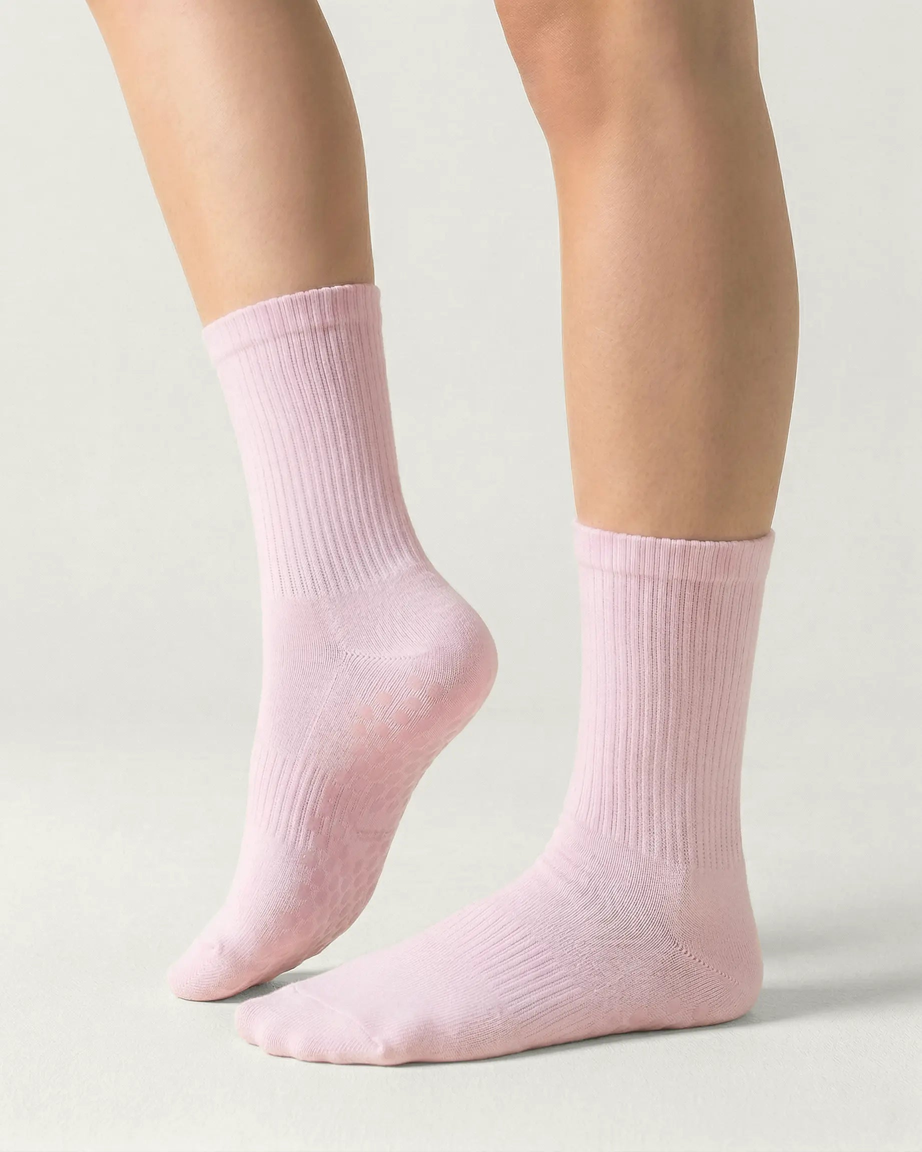 pink | 01 | Pink crew grip socks side lift view showing ribbed texture and crew length