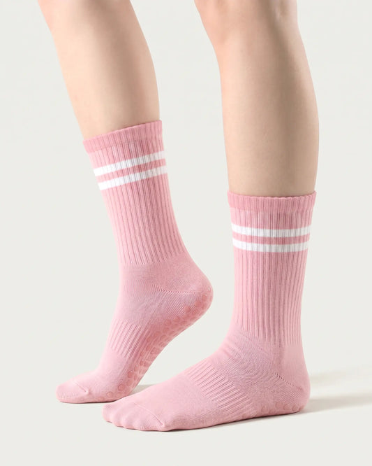 pink | 01 | Pink double-stripe crew grip socks side lift view showing ribbed texture, contrast stripe detail, and crew length