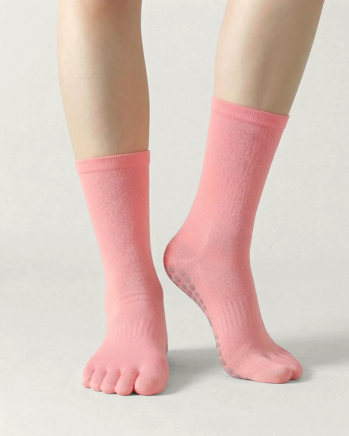 pink | 04 | Pink minimal five-toe grip socks front standing view showing toe separation, grip sole detail, and minimal silhouette