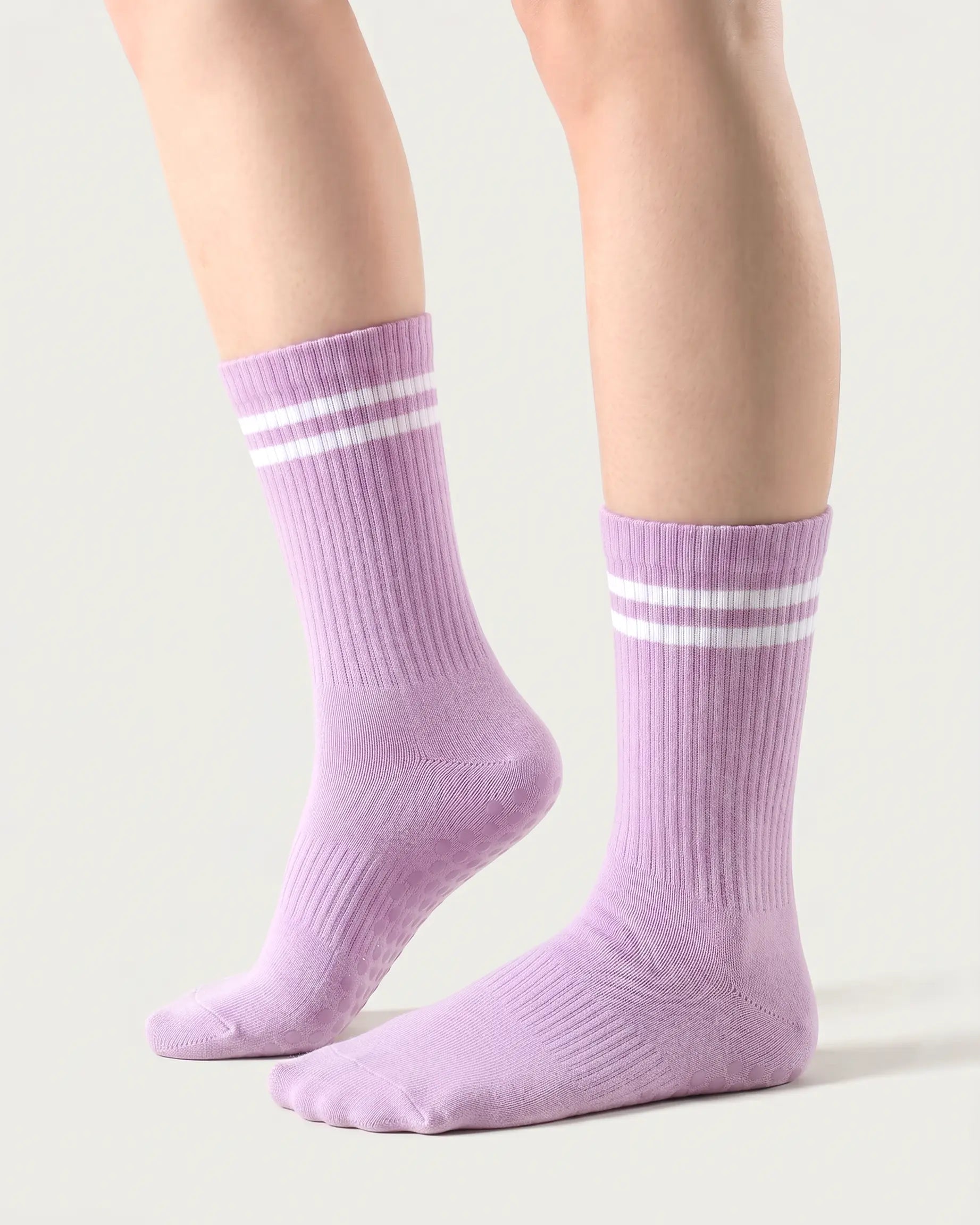 purple | 01 | Purple double-stripe crew grip socks side lift view showing ribbed texture, contrast stripe detail, and crew length