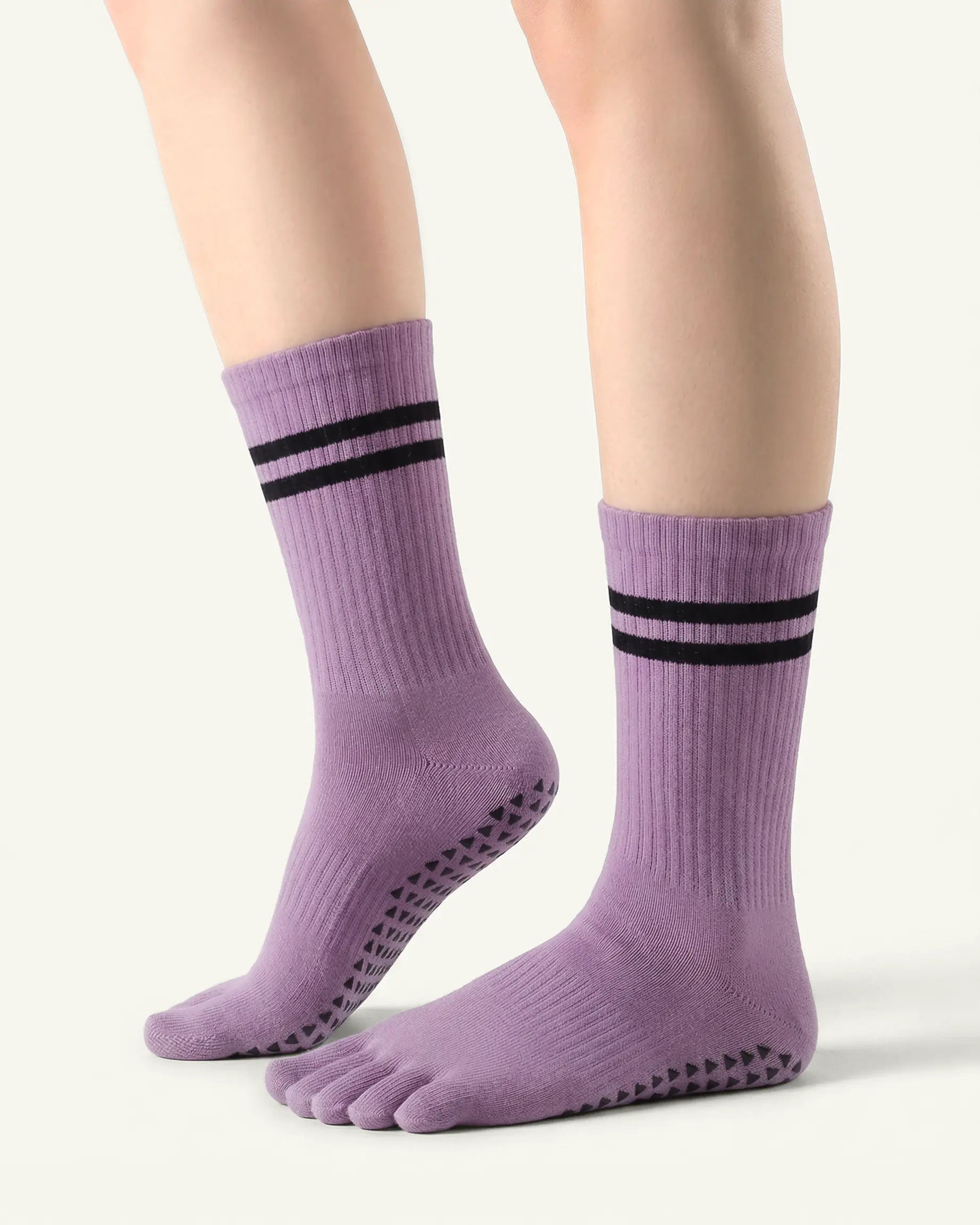 purple | 01 | Purple double-stripe five-toe grip socks side lift view showing ribbed texture, stripe detail, and toe separation