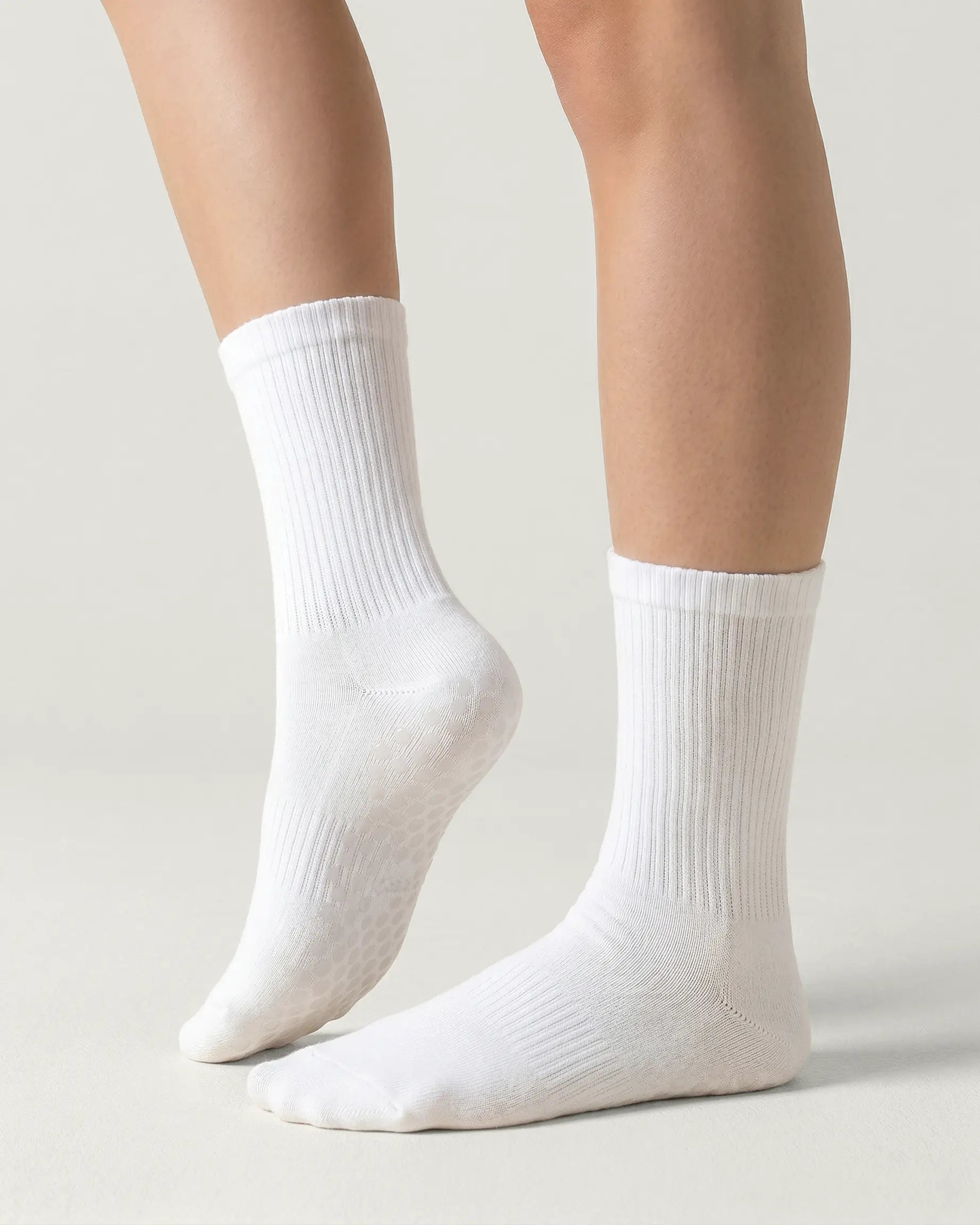 white | 01 | White crew grip socks side lift view showing ribbed texture and crew length