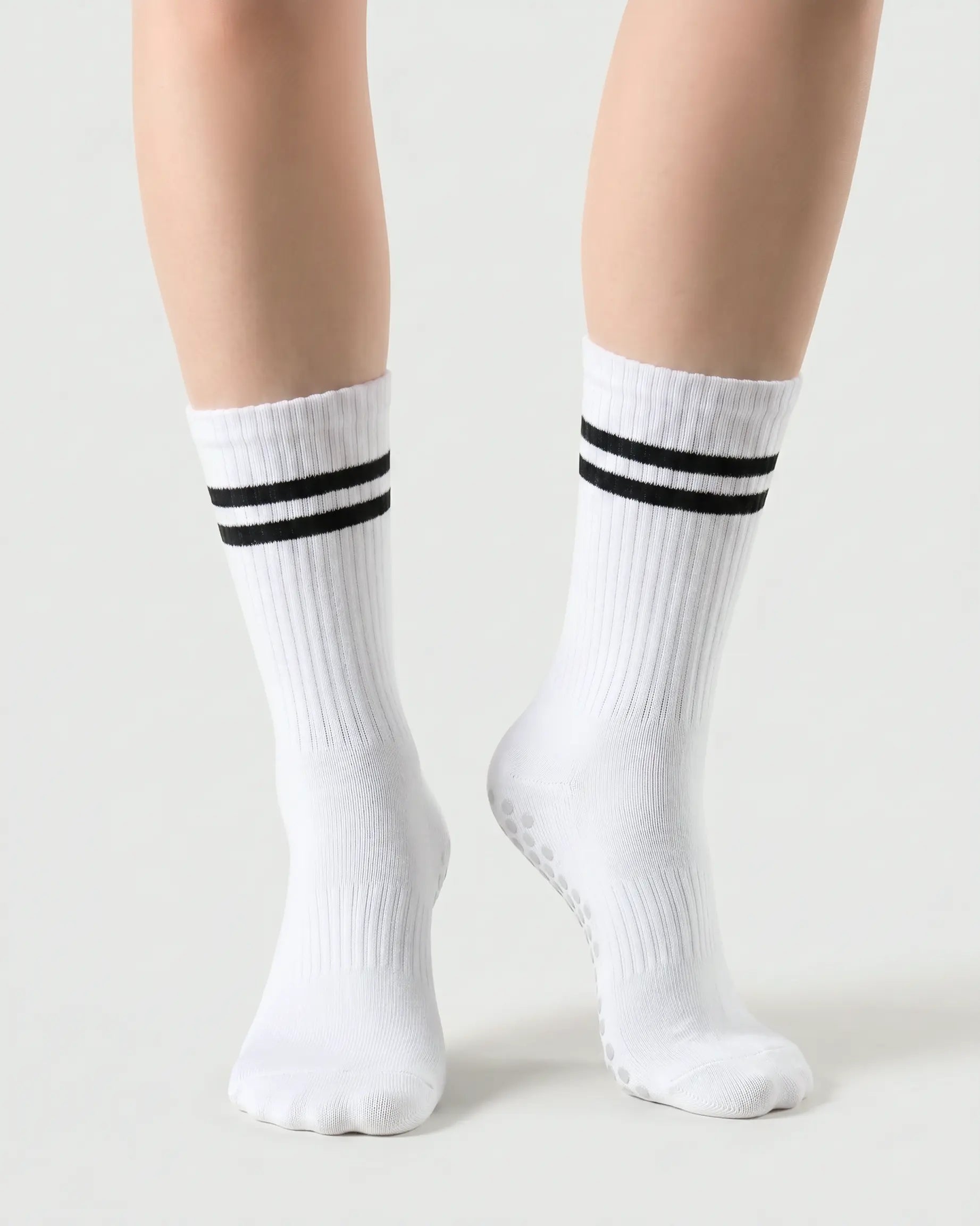 white | 04 | White double-stripe crew grip socks front angled view showing ribbed texture, stripe detail, and crew height