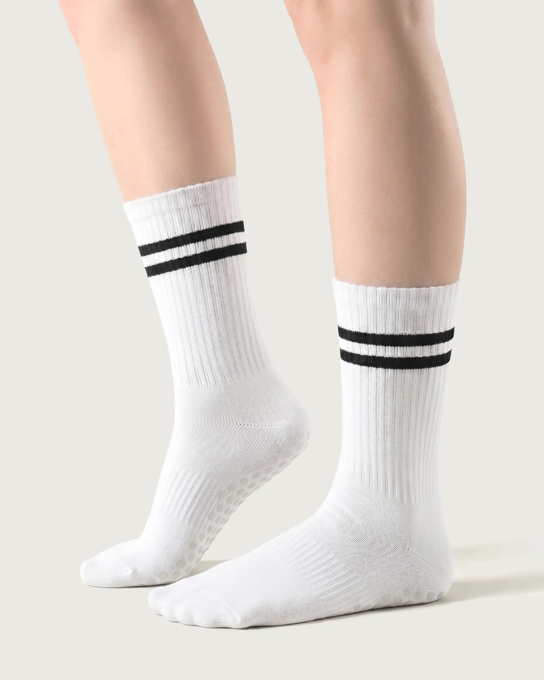 white | 01 | White double-stripe crew grip socks side lift view showing ribbed texture, contrast stripe detail, and crew length