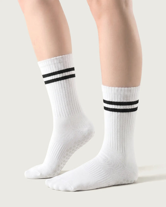 white | 01 | White double-stripe crew grip socks side lift view showing ribbed texture, contrast stripe detail, and crew length