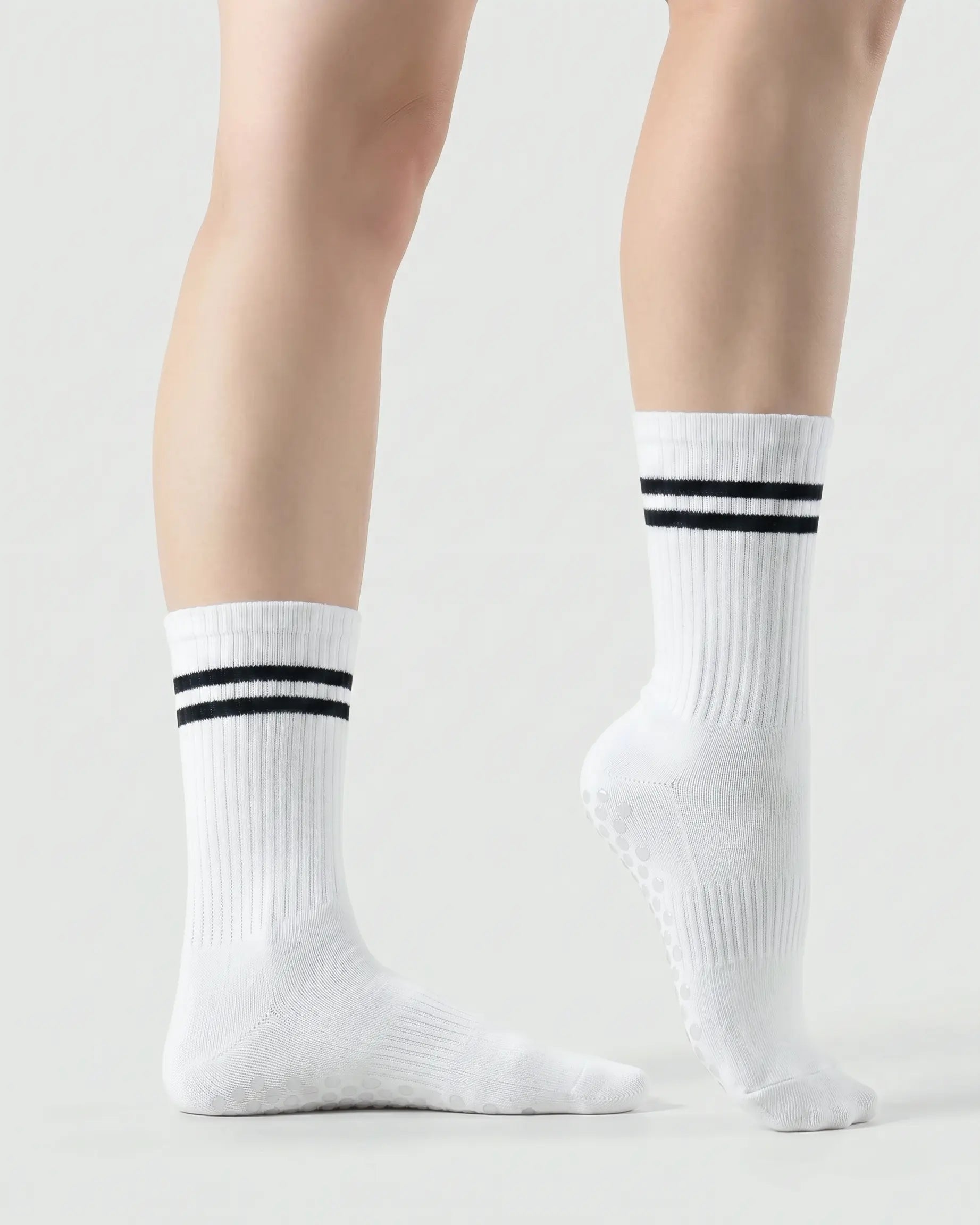 white | 03 | White double-stripe crew grip socks side standing view showing clean silhouette, contrast stripe detail, and crew fit
