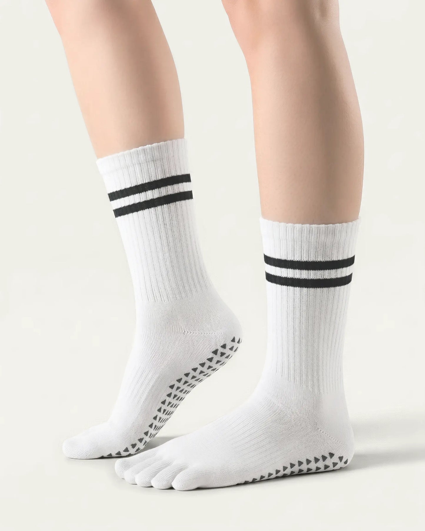 white | 01 | White double-stripe five-toe grip socks side lift view showing ribbed texture, stripe detail, and toe separation