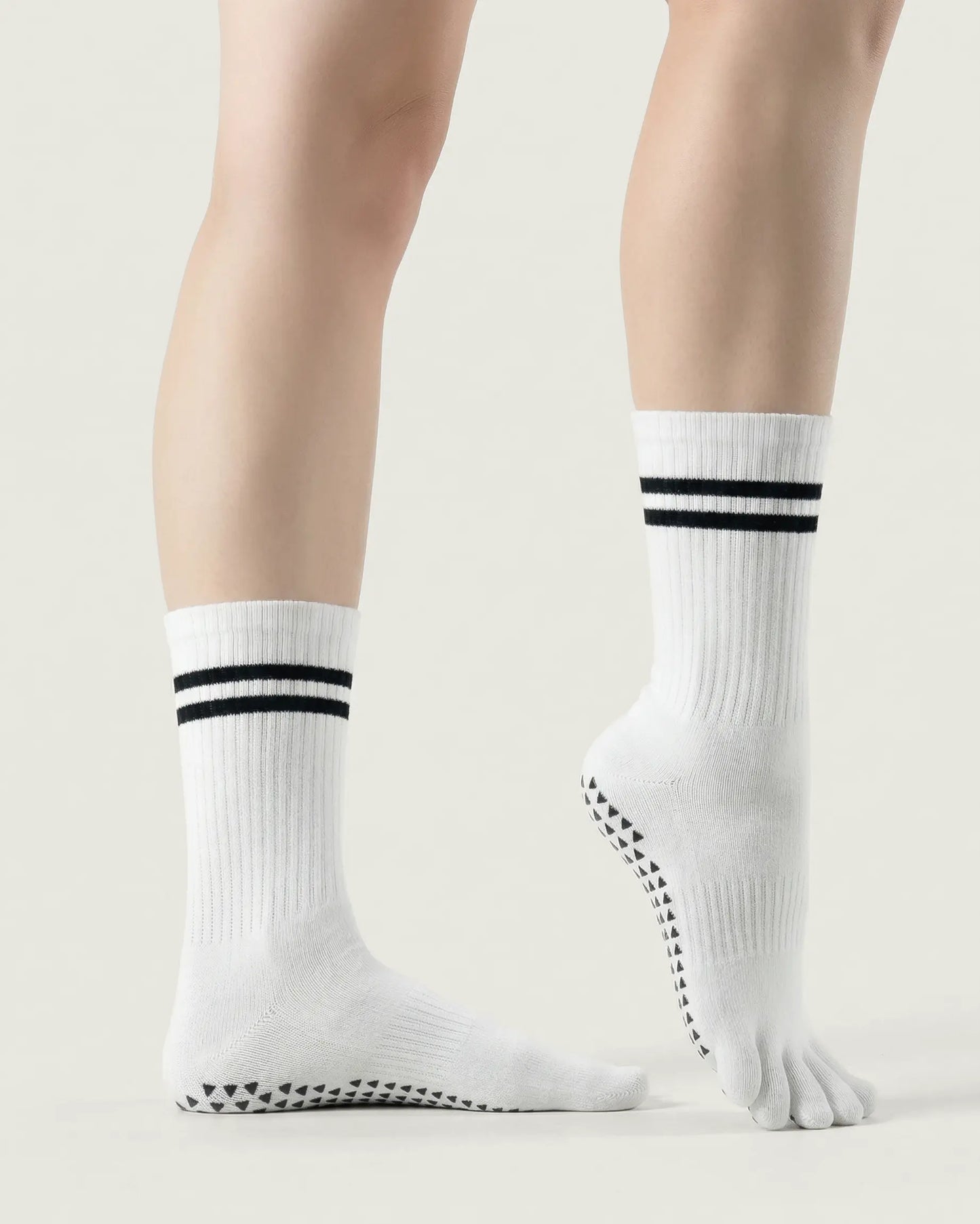 white | 03 | White double-stripe five-toe grip socks side standing view showing ribbed texture, stripe detail, and five-toe silhouette
