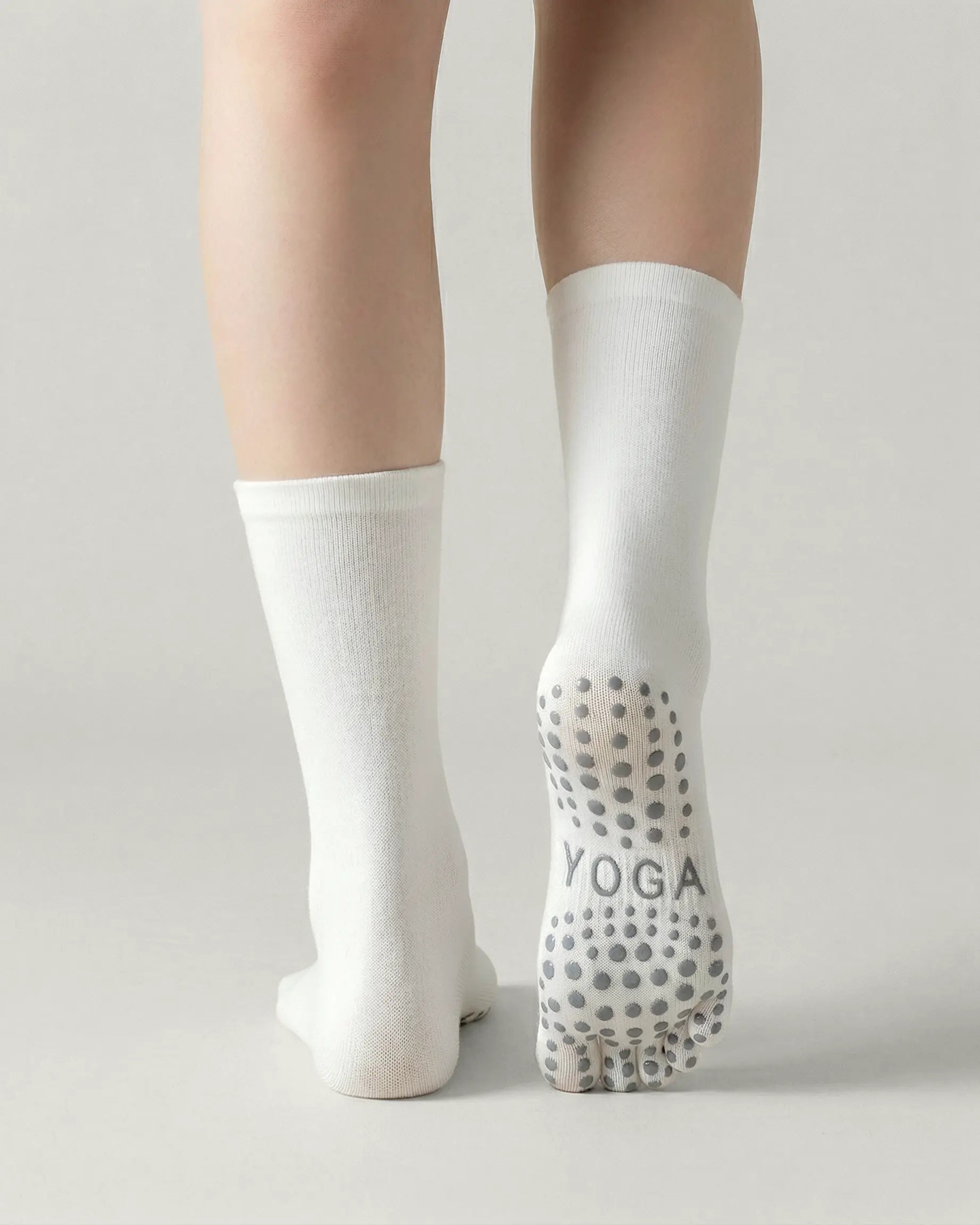 white | 02 | White minimal five-toe grip socks back view showing sole grip pattern, toe separation, and clean silhouette