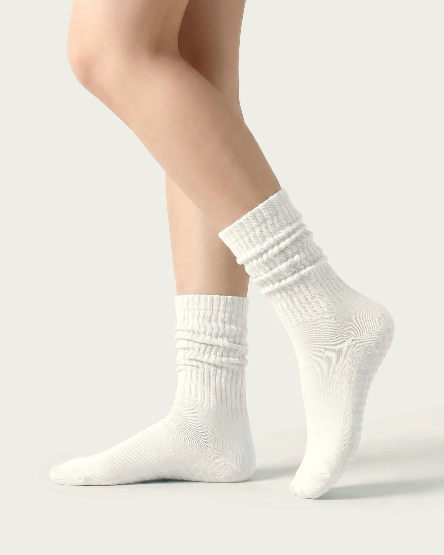 white | 01 | White slouch grip socks side slouch standing view showing relaxed ribbed texture, crew length, and soft studio styling