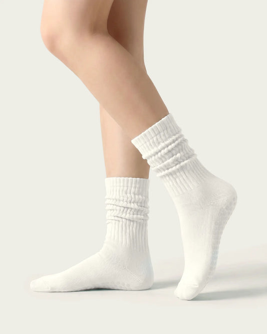 white | 01 | White slouch grip socks side slouch standing view showing relaxed ribbed texture, crew length, and soft studio styling