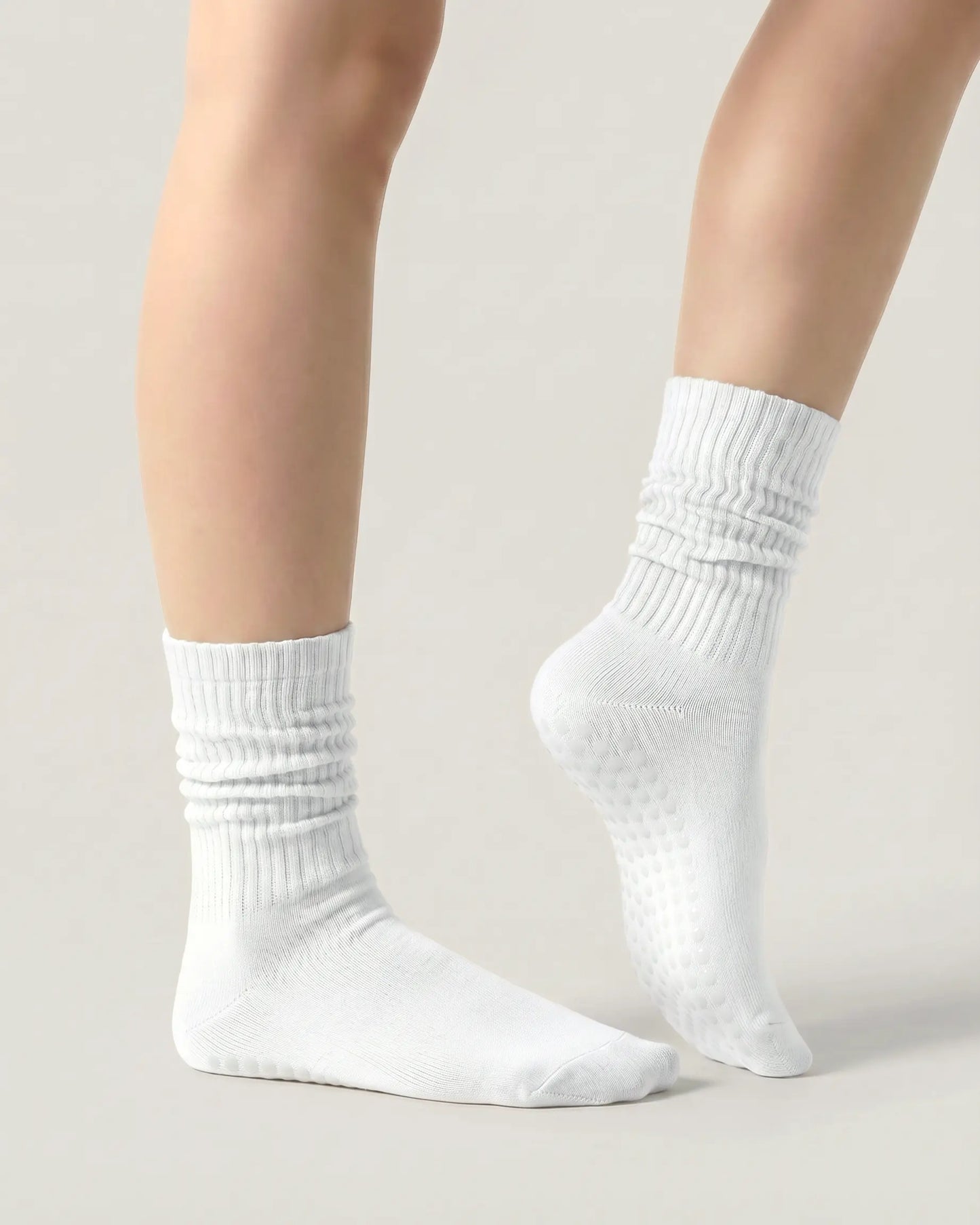 white | 03 | White slouch grip socks side standing view showing relaxed slouch fit, ribbed knit texture, and minimal studio look