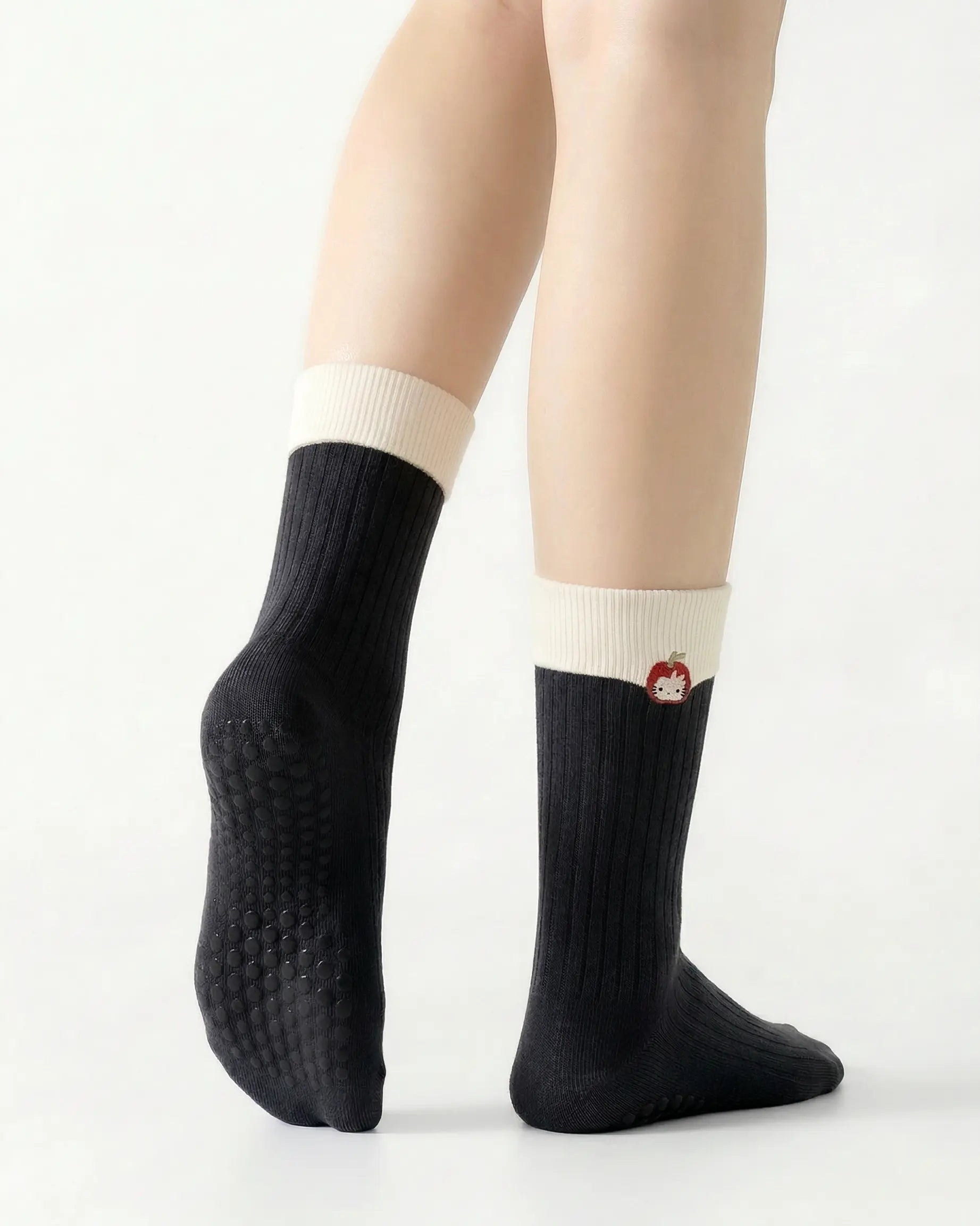 black | 02 | Black character embroidery crew grip socks back side view showing grip sole detail, contrast black cuff, and embroidered cat motif