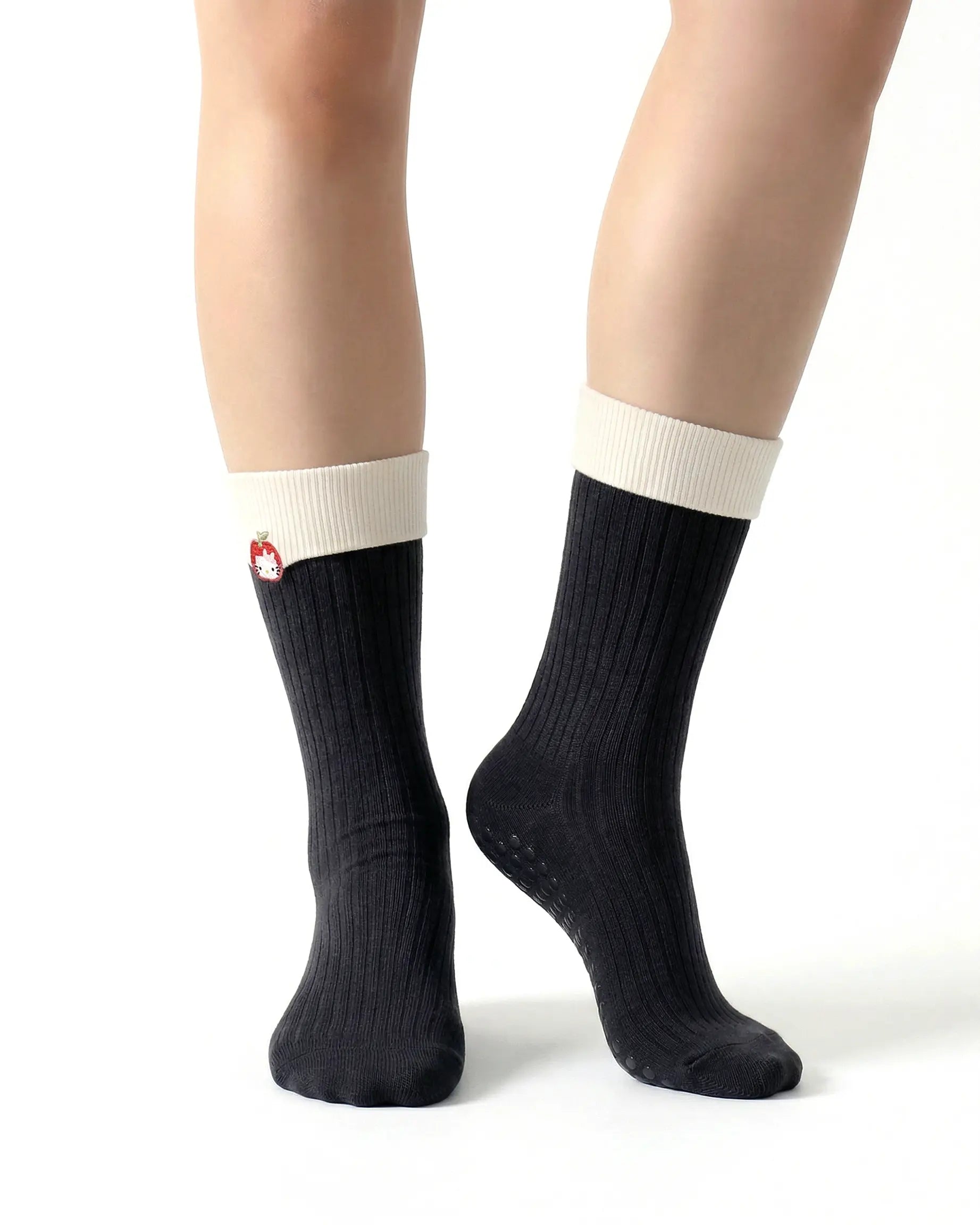 black | 04 | Black character embroidery crew grip socks front standing view showing contrast cuff, ribbed knit texture, and clean non-slip crew sock shape