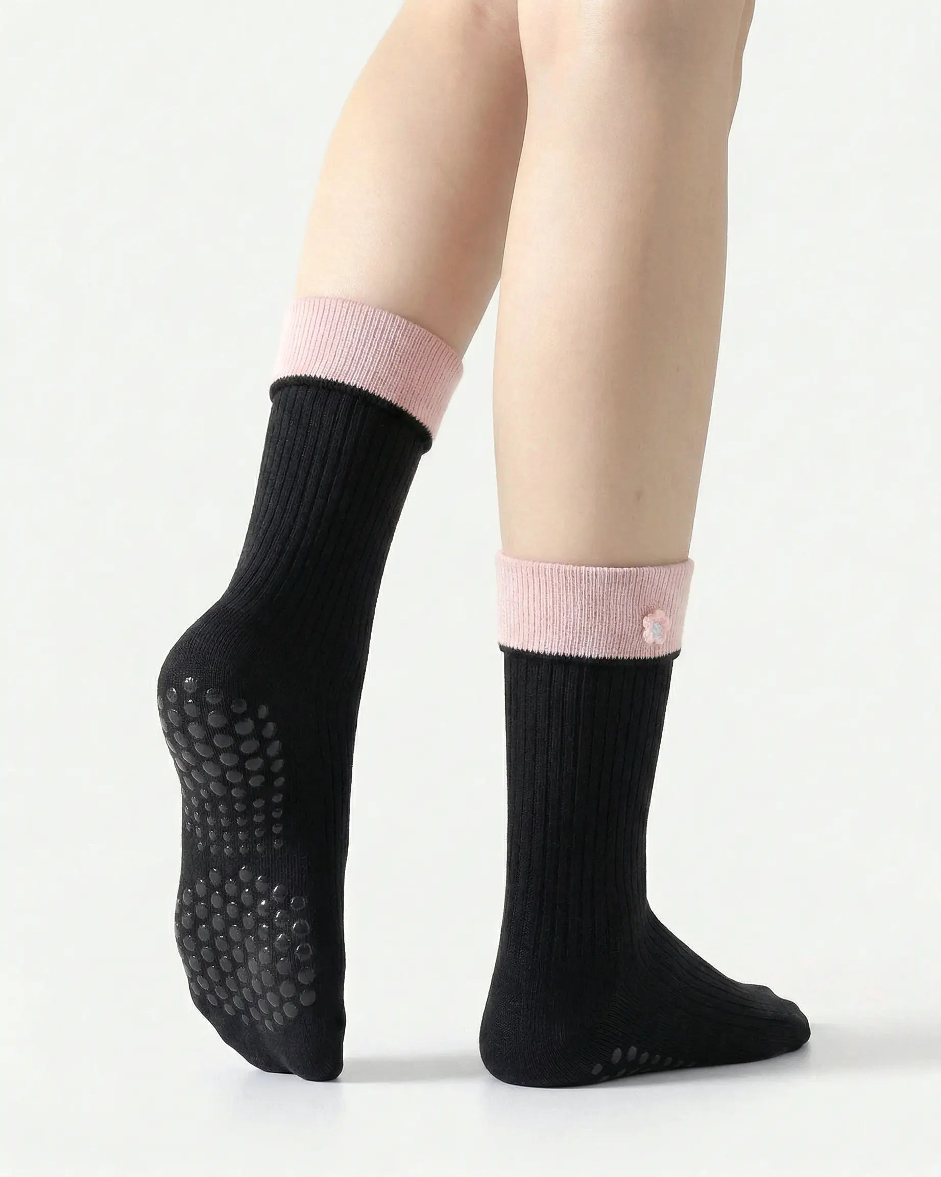black | 02 | Black floral detail crew grip socks back side view showing grip sole detail, contrast cuff, and flower embroidery on fold-over cuff