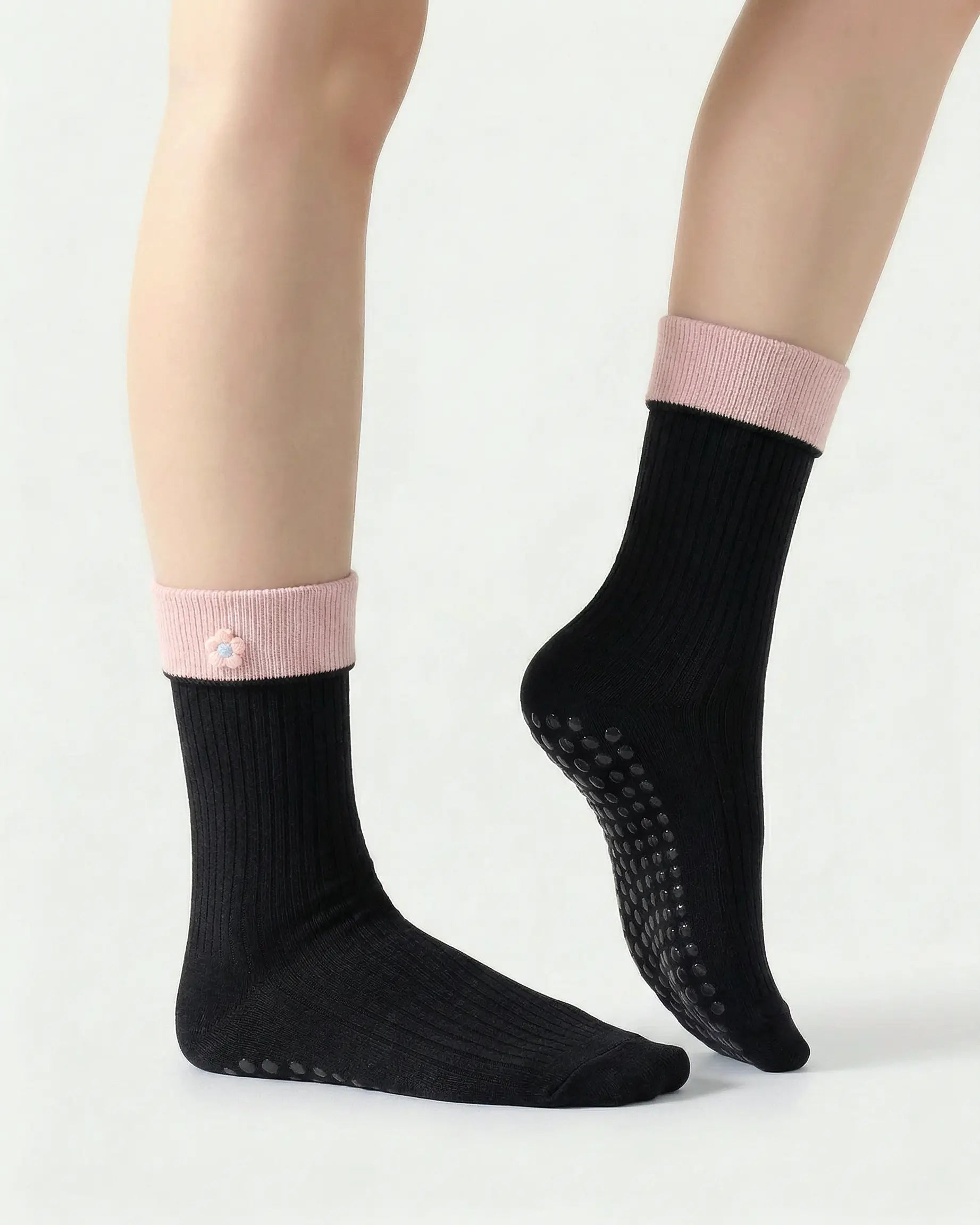 black | 03 | Black floral detail crew grip socks side detail view showing fold-over contrast cuff, ribbed crew silhouette, and floral embroidery accent