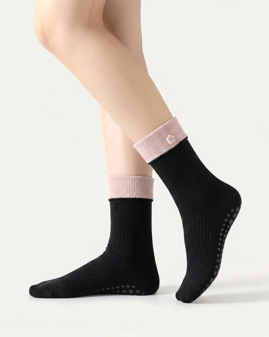 black | 01 | Black floral detail crew grip socks side standing view showing contrast cuff, ribbed knit texture, and small flower embroidery detail