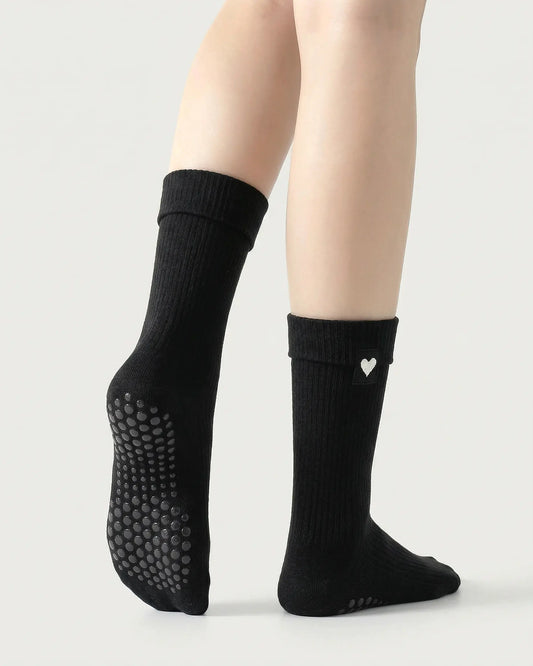 black | 02 | Black heart detail crew grip socks back side view showing grip sole detail, fold-over cuff, and black heart embroidery
